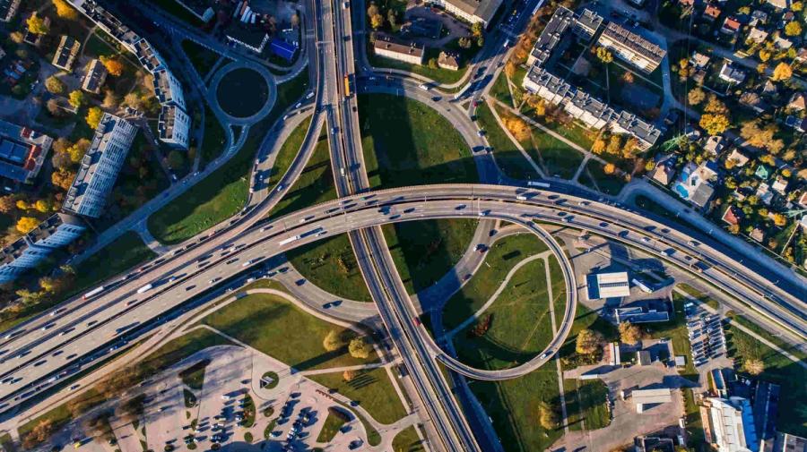 Aerial photo of multiple highways above a green park.