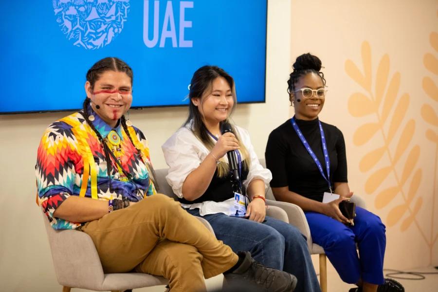 We must support, equip and invest in future generations. Image shows a group of young people on a panel at COP.