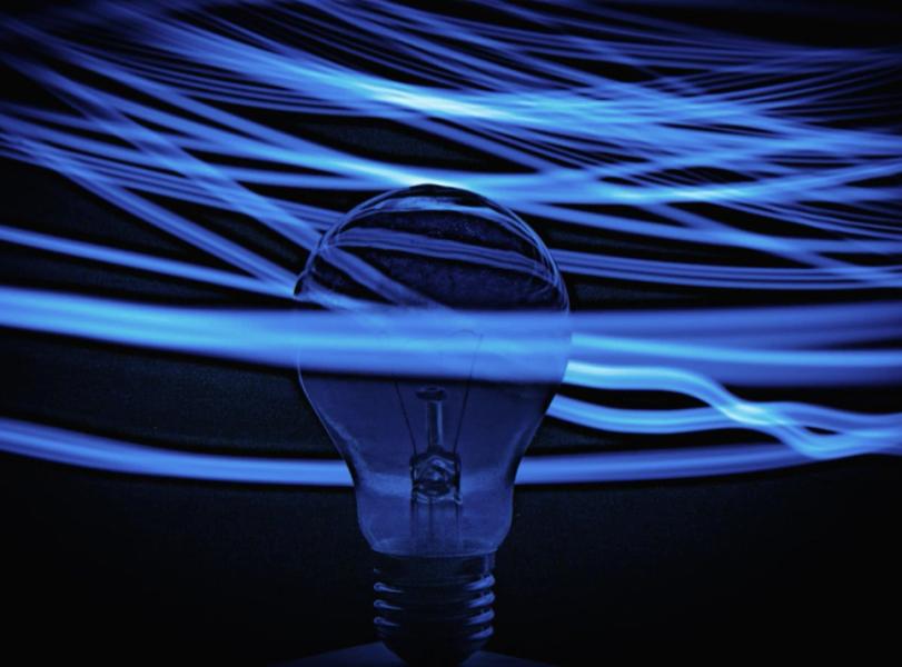 lightbulb with electricity waves around