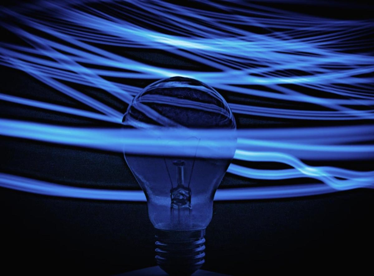 lightbulb with electricity waves around