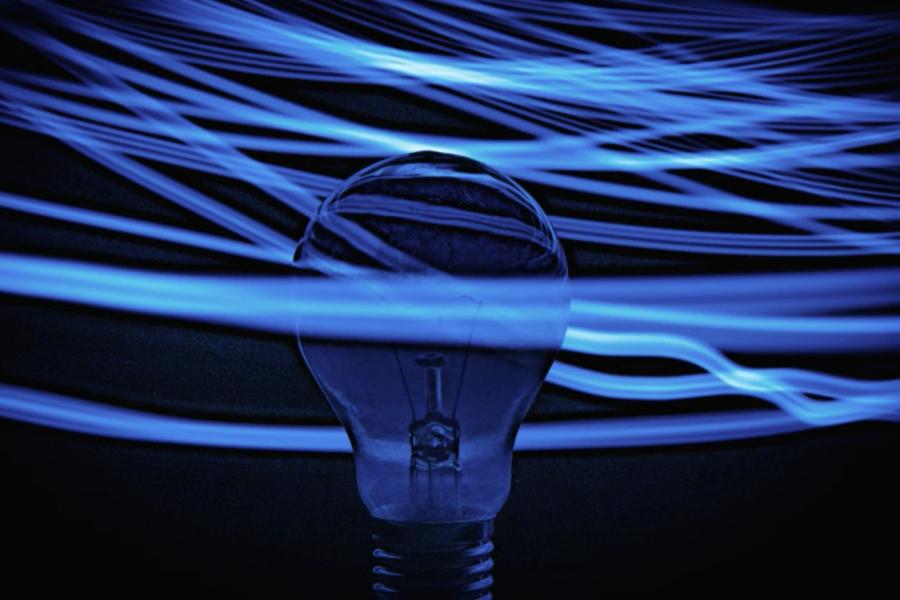 lightbulb with electricity waves around