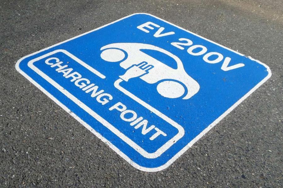 Electric vehicle charging sign painted on the road