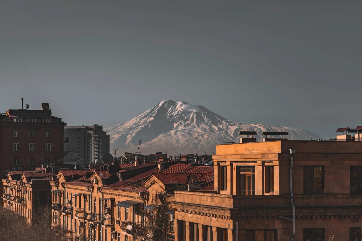 Snow-capped Mount Ararat rising above the stone-built rooftops of Yerevan, Armenia