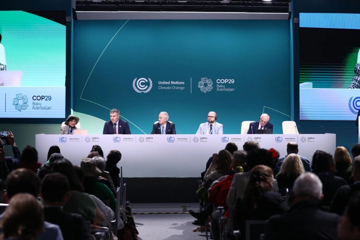 Five tips to supercharge your communications at COP29. Image shows a panel of 5 individuals, with and audience in the foreground. Behind the panelists are the COP29 and United Nations logos.