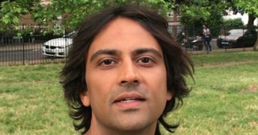 Picture of man's face, brown skin with dark wavy hair