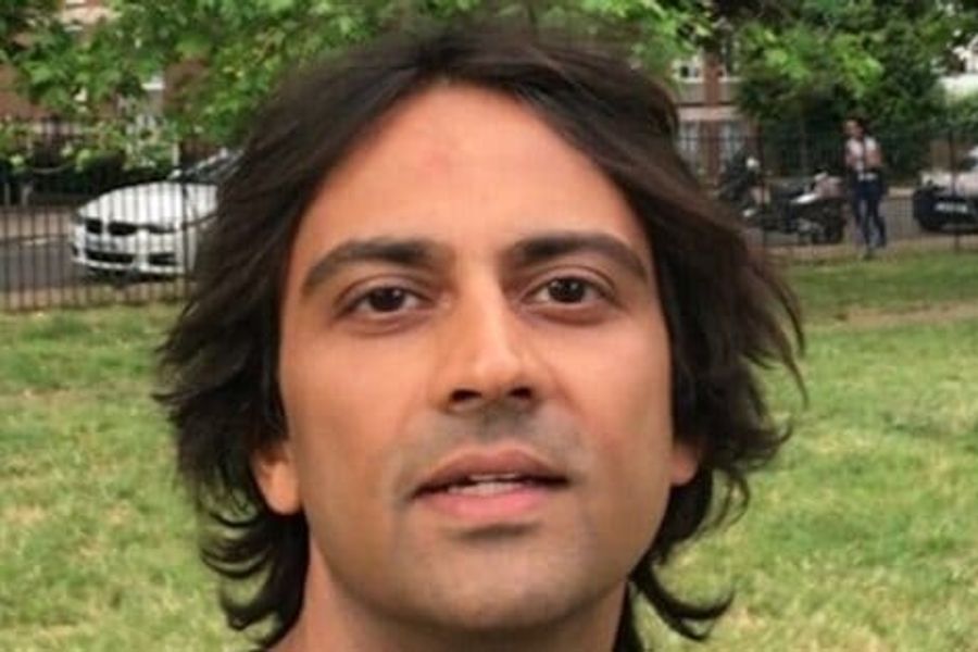 Picture of man's face, brown skin with dark wavy hair