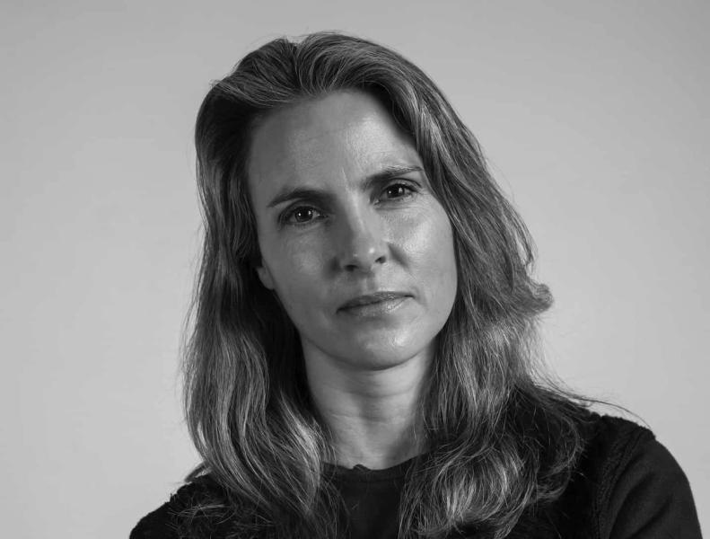 Black and white shot of white woman looking directly at camera.