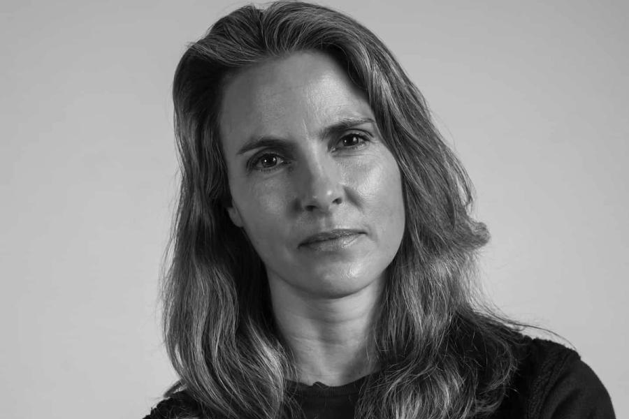 Black and white shot of white woman looking directly at camera.