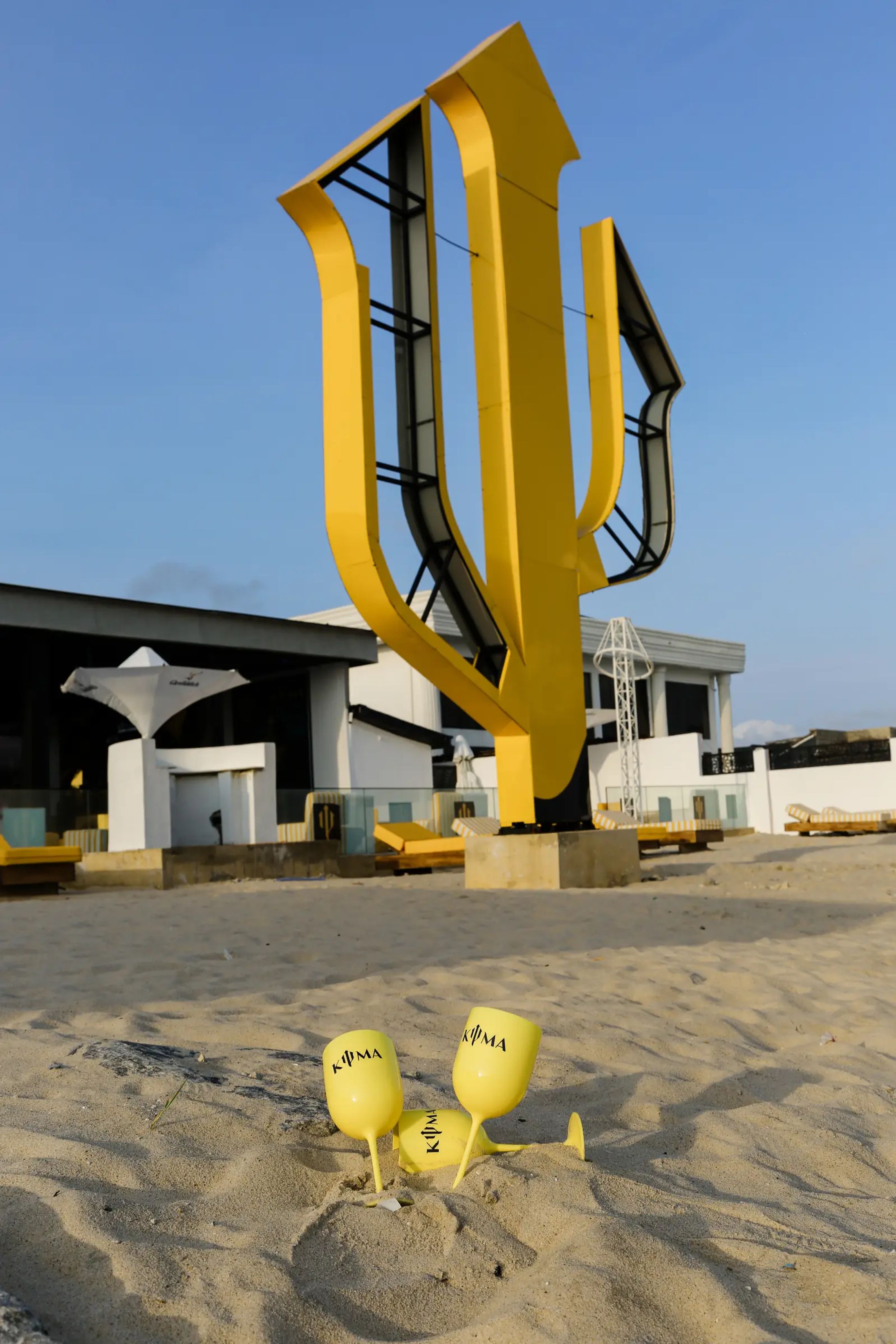 Two cocktails resting on the sand