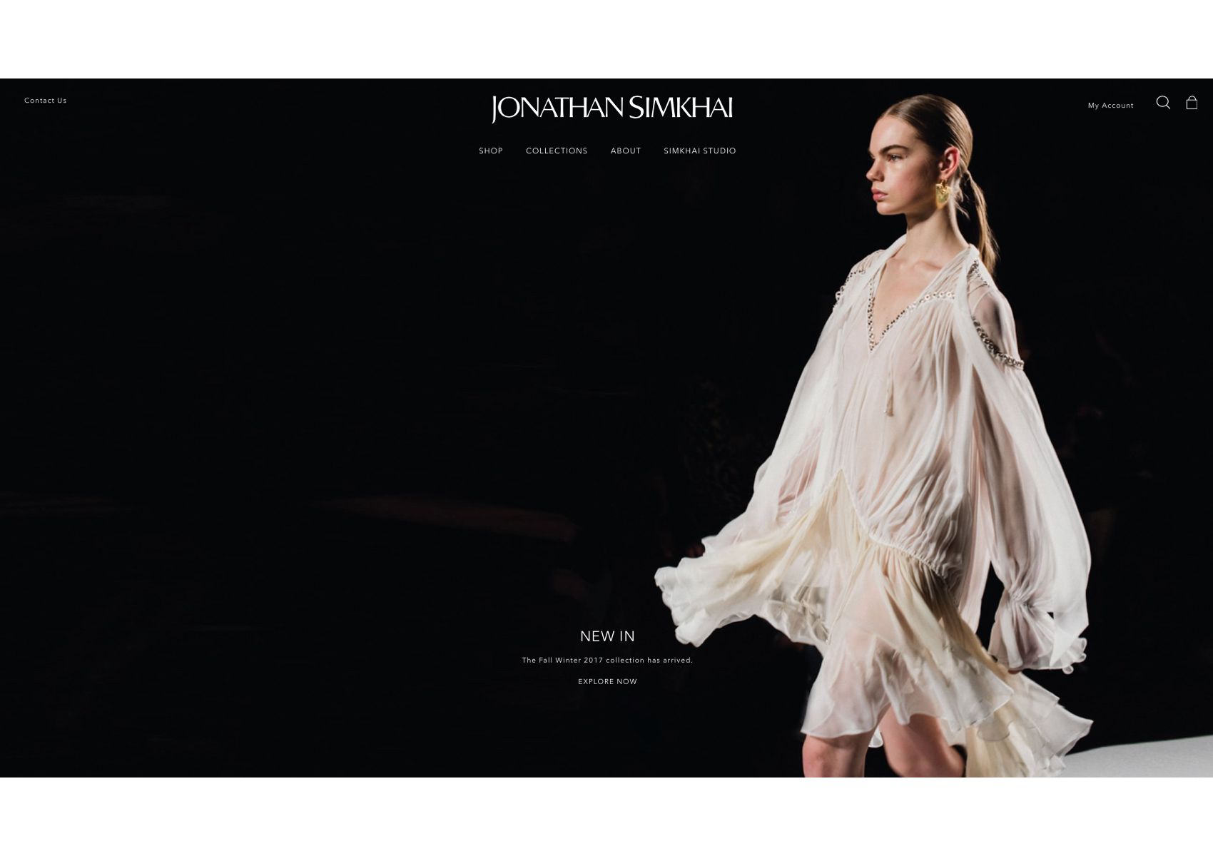 Website homepage showing a model walking a runway in a white dress