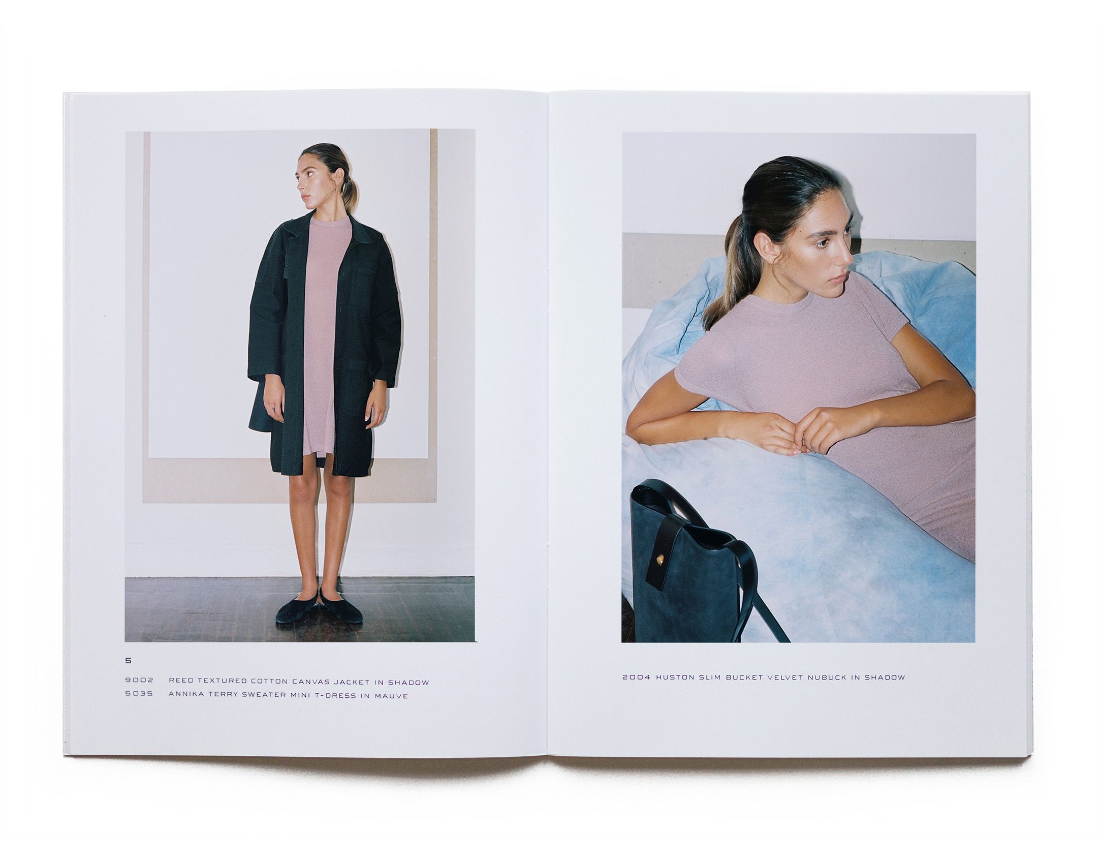Two page spread of a printed fashion lookbook showing a model wearing a pink terry dress and a navy blue coat with a handbag