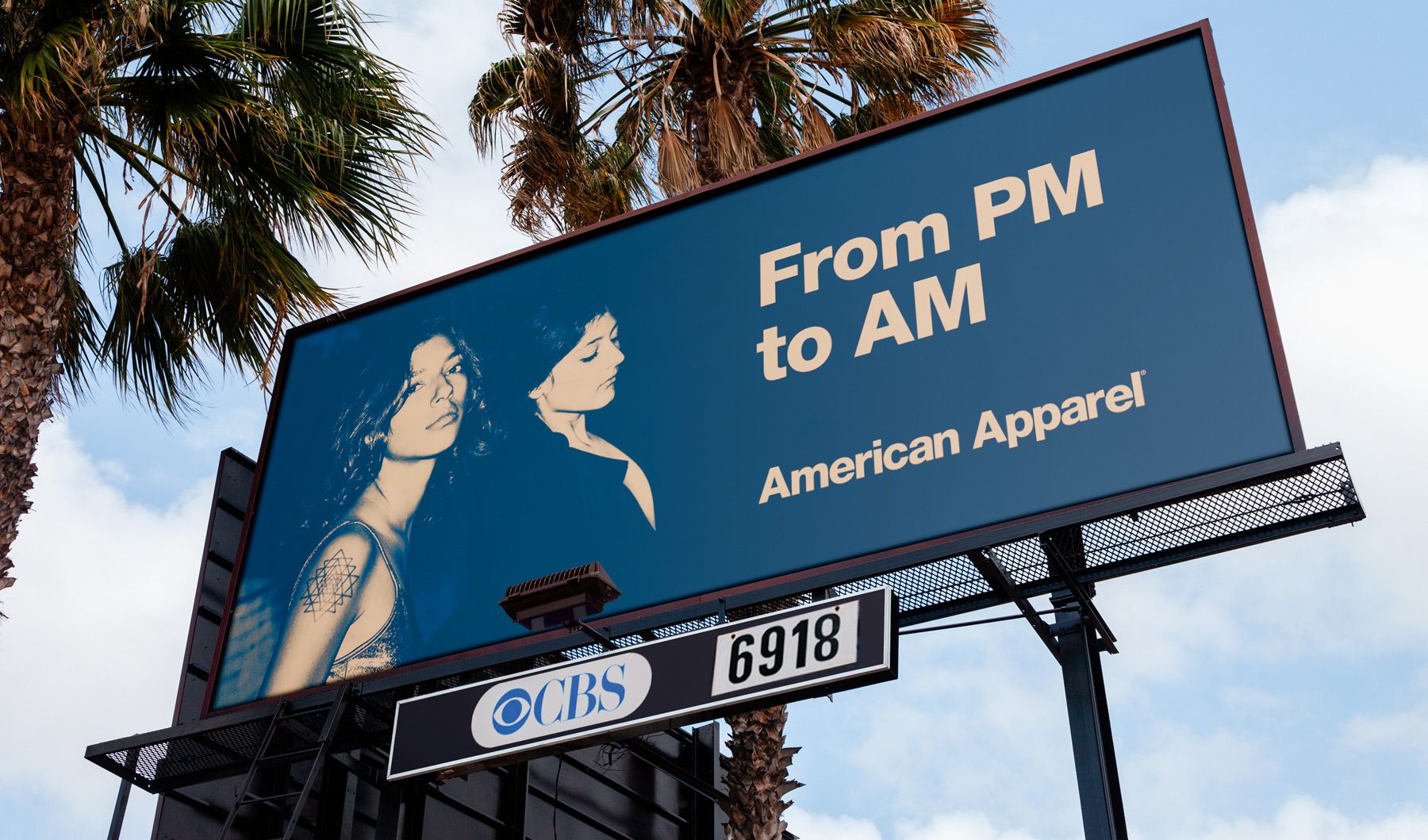 A billboard showing an image of two women and a headline that reads "From PM to AM - American Apparel"