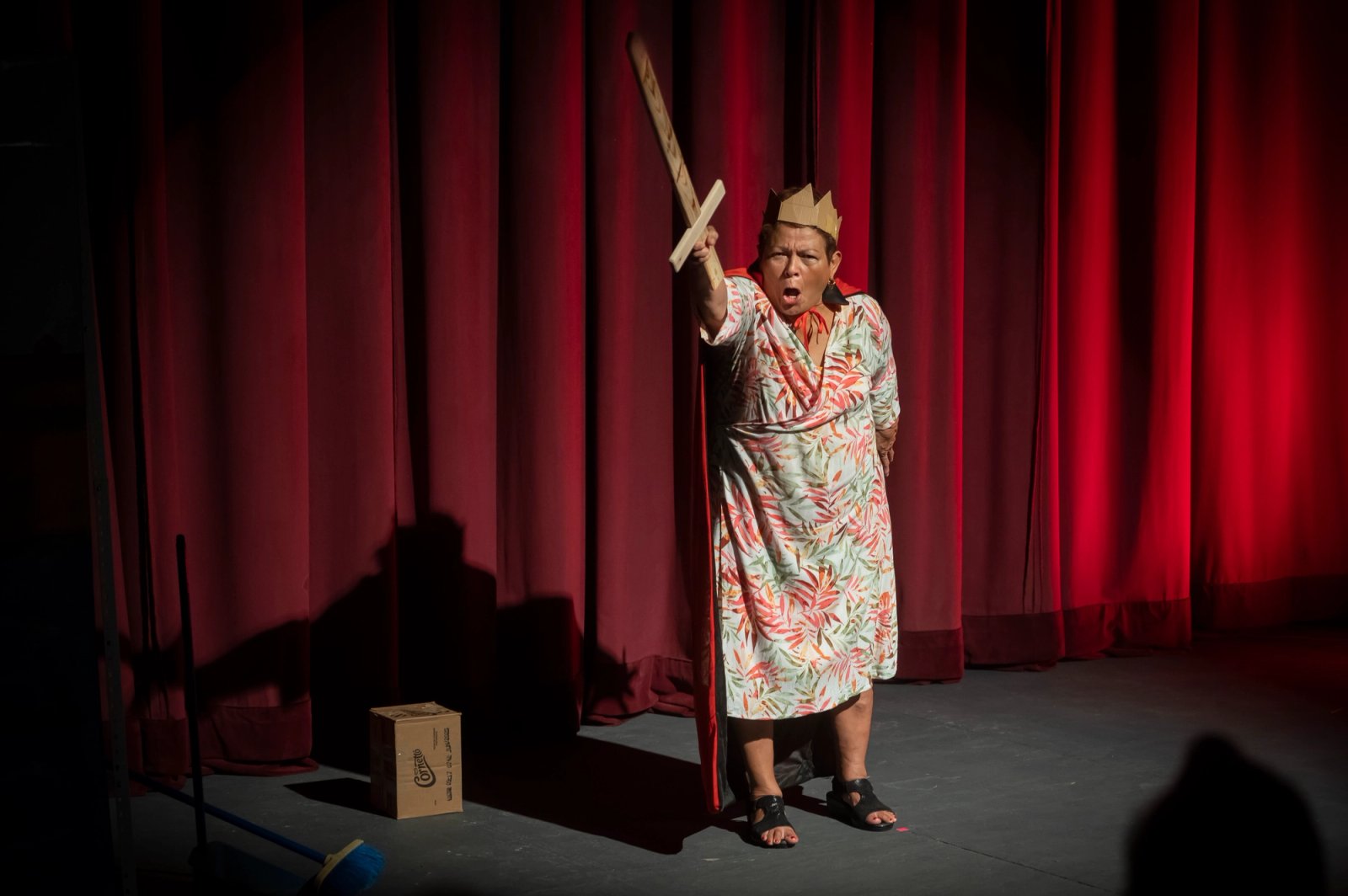 Josefina Orlaineta with a paper crown, with a raised paper sword in her hand