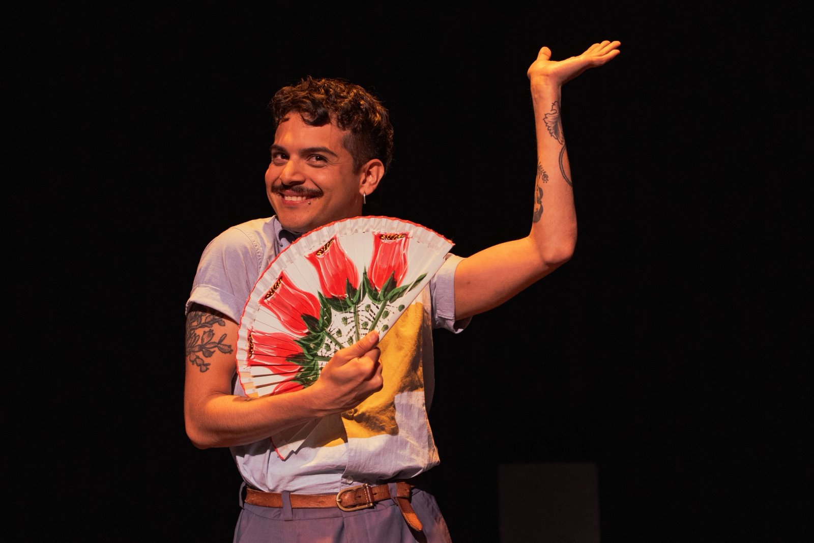 Daniel Galicia holding a fan. photo by Emma Rosa.