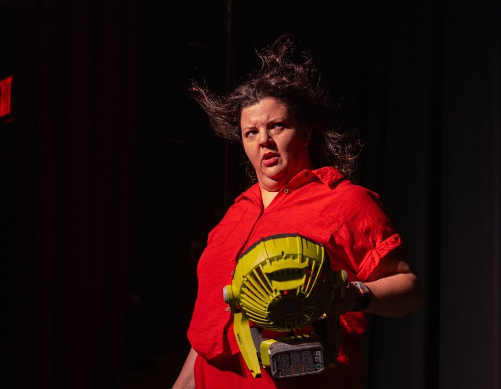 Diane Jorge with a fan in her hand that is blowing her hair back