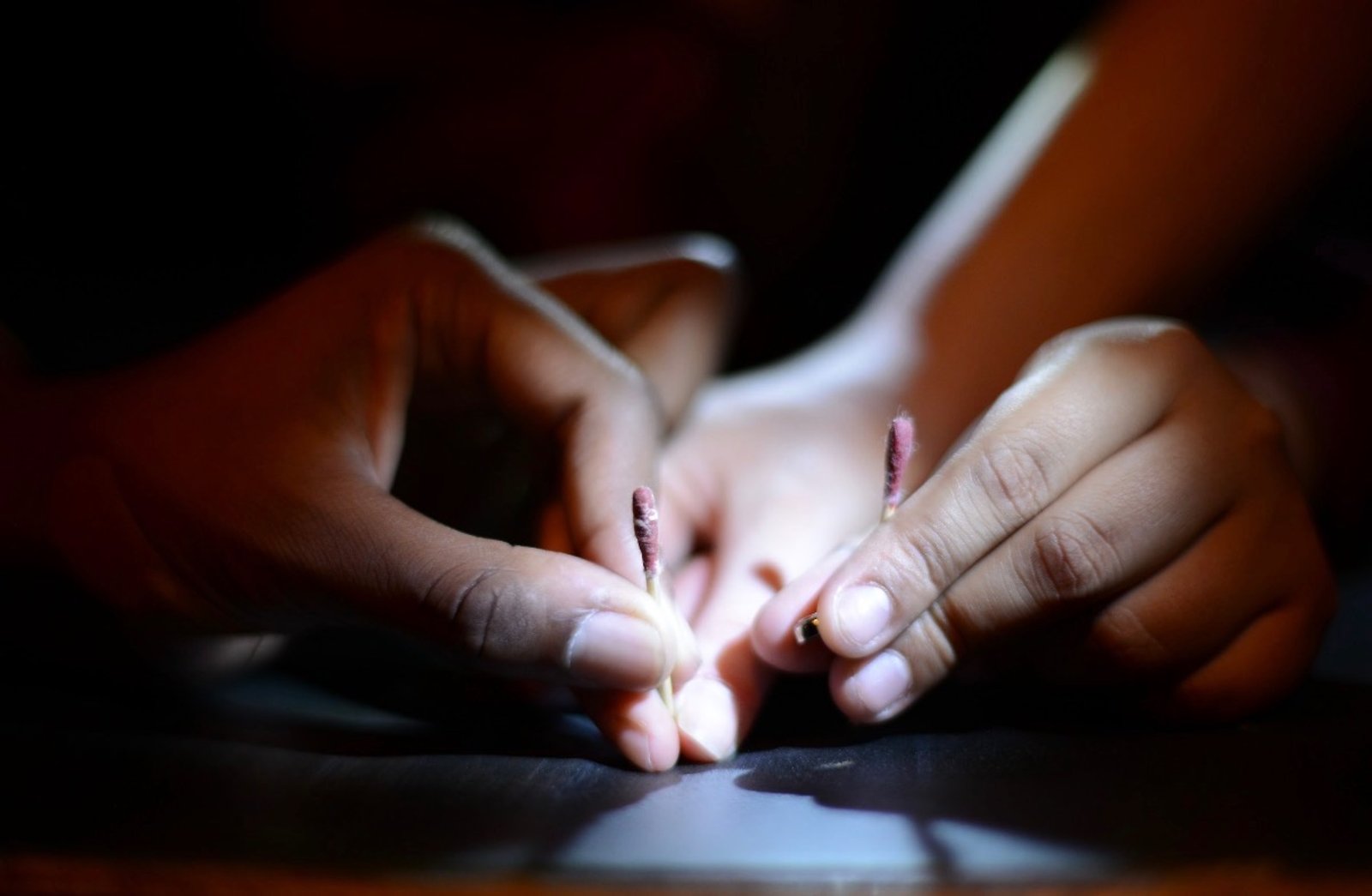 hands holding matches. photo by Elena Kantor.