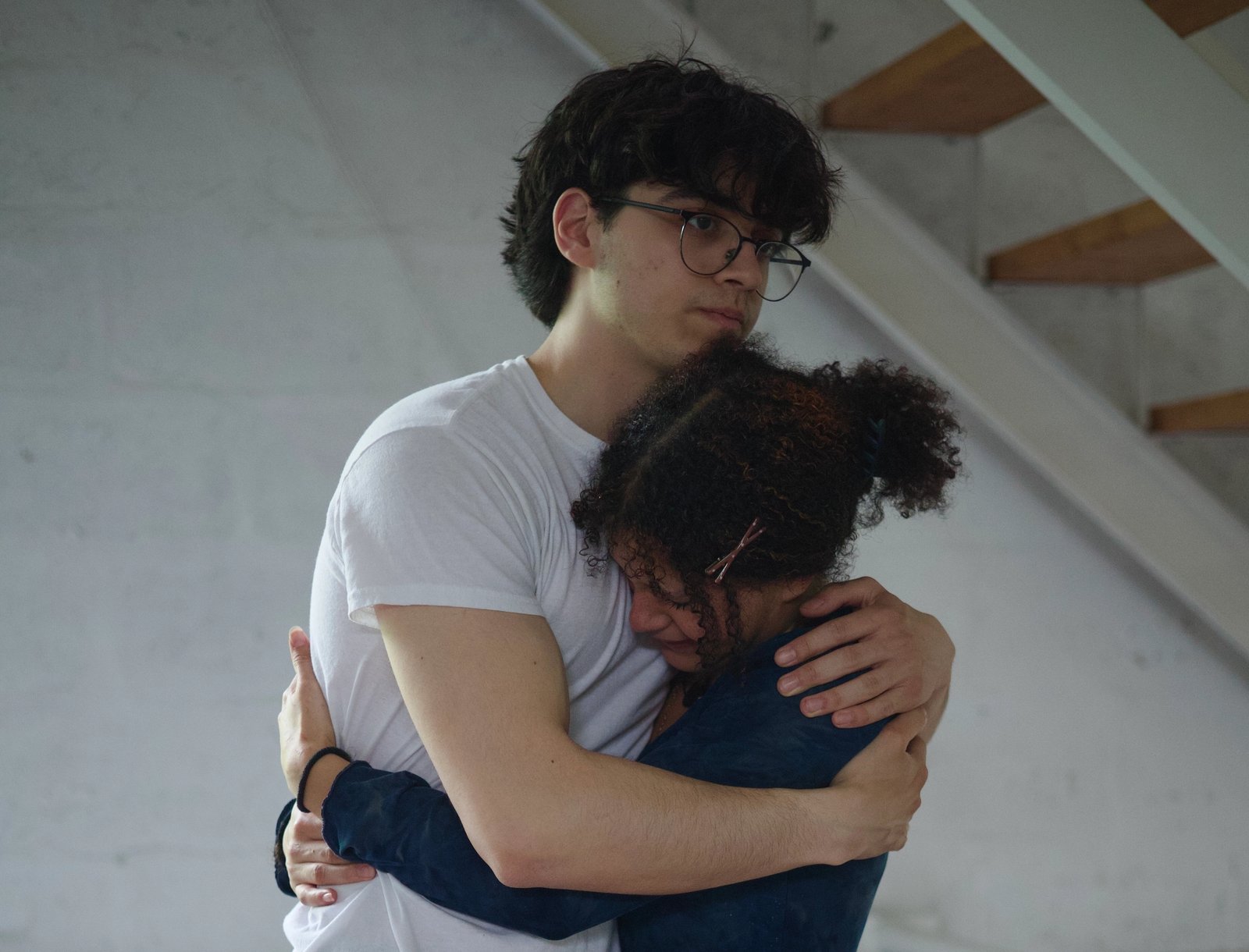 two of the actors embracing