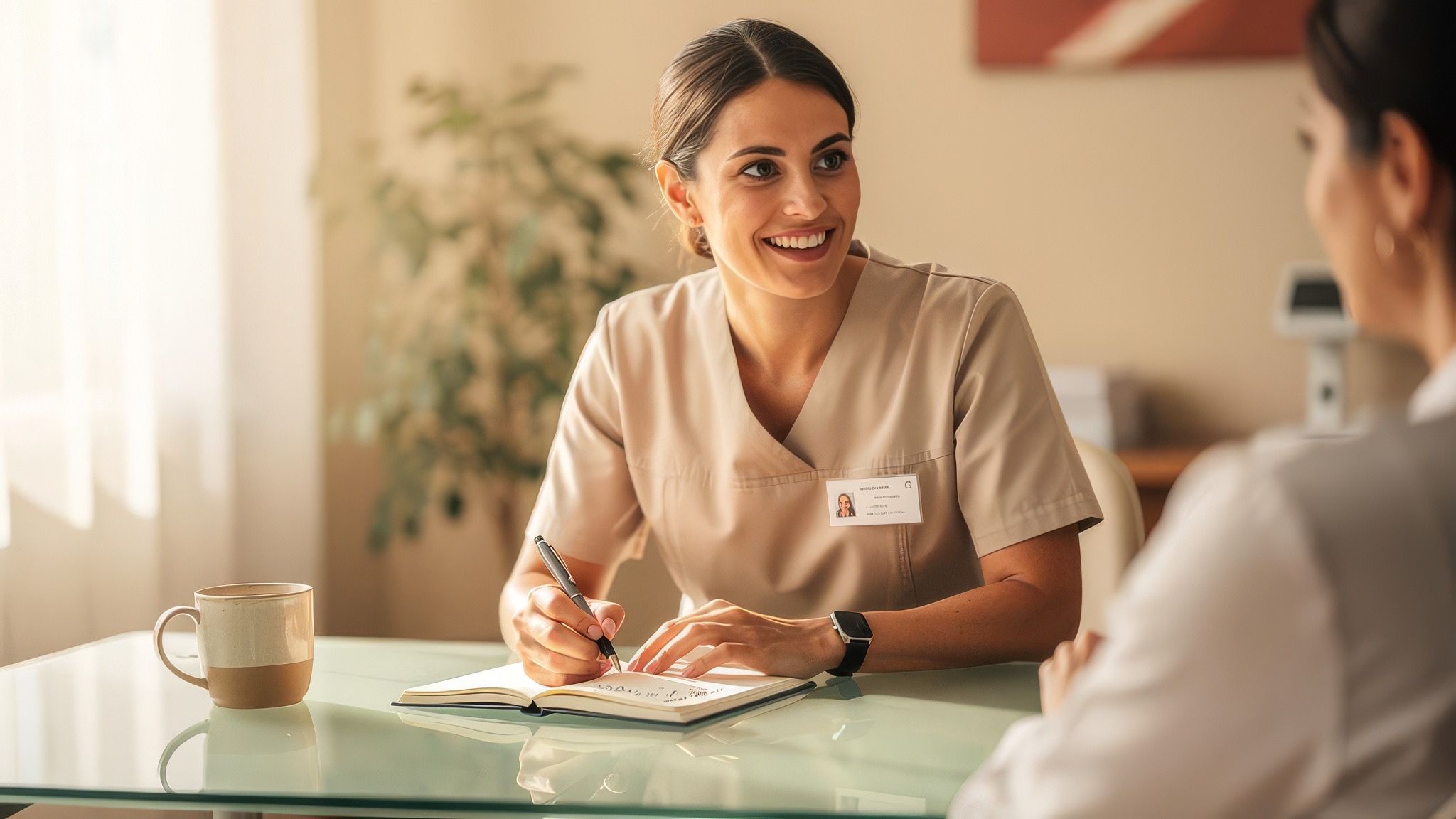 A care team member answering questions in a warm clinic setting.