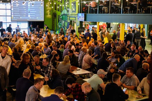 A hall filled to the brim with people chatting and having a good time