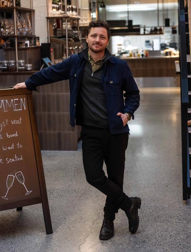 William by a sign at Tollboden Restaurant