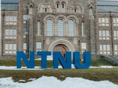 NTNU main building entrance with NTNU letters in front