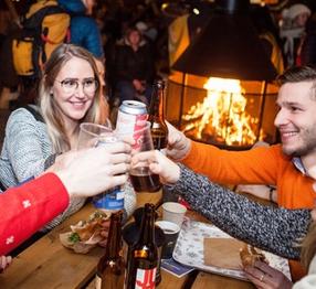 5 people toasting at makeshuft cafe table at Trondheim Christmas Market