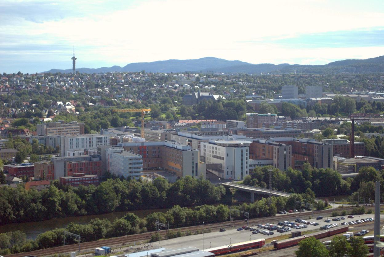 St. Olavs Hospital area with railway and Nidelva river in foreground. Photo taken from west of the area.