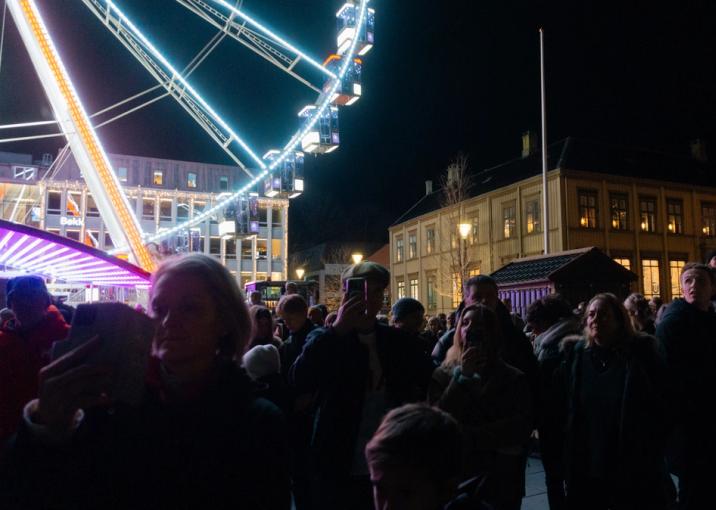 The people of Trondheim gather to witness the yearly lighting of the Christmas tree in the town square.