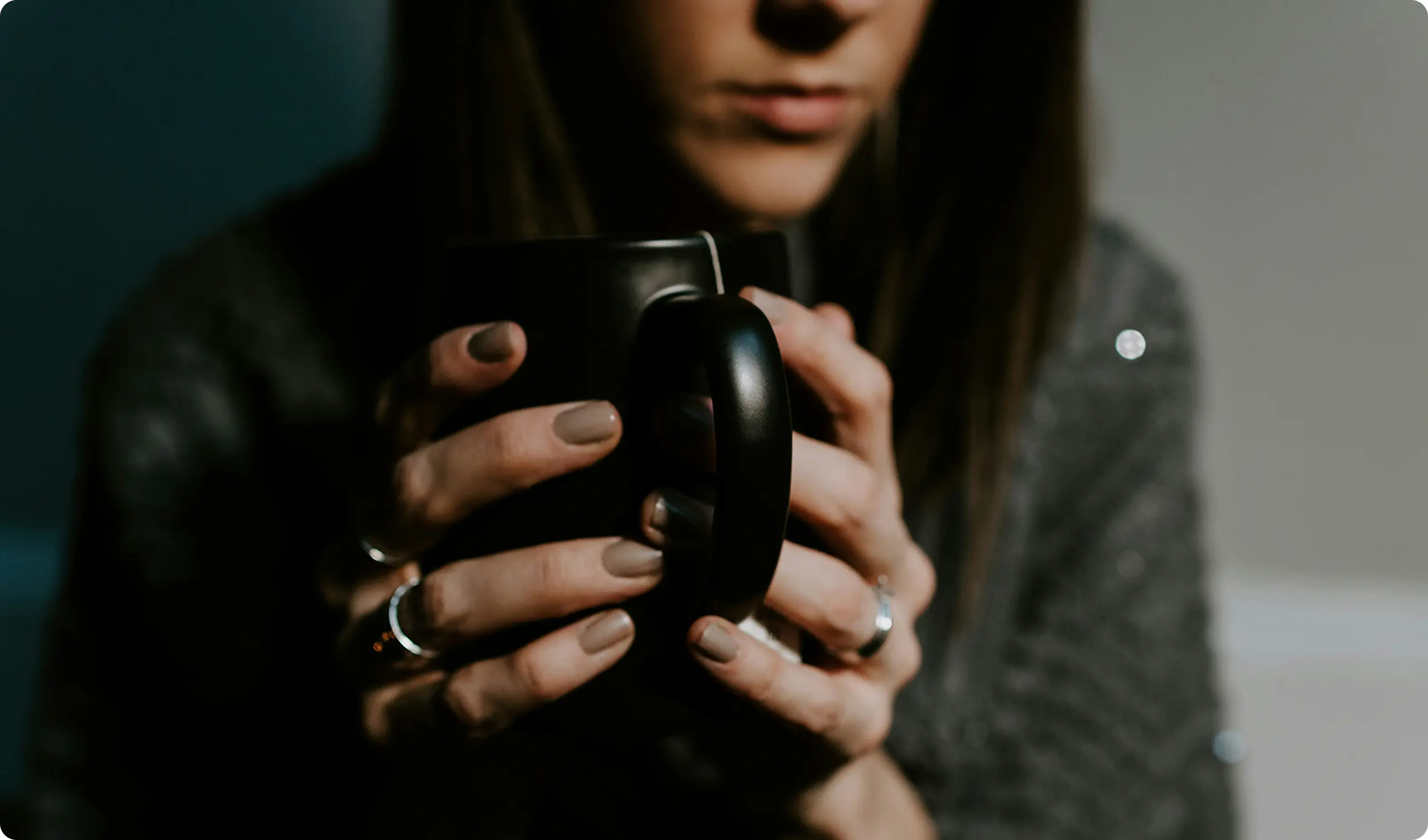 A woman holding a cup of tea