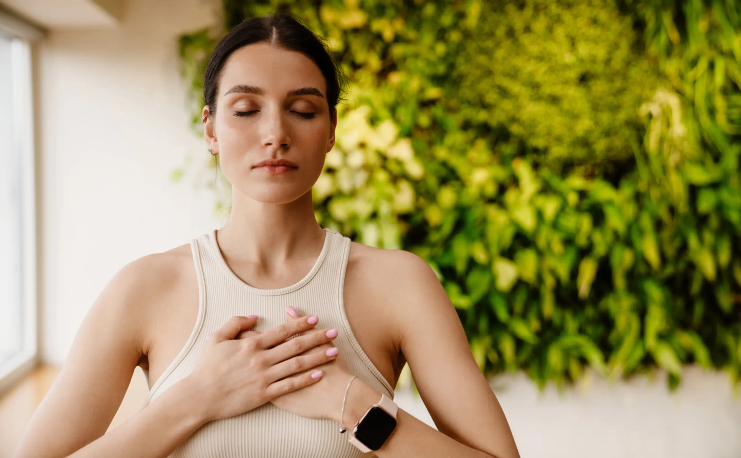    woman closed eyes holding hands on chest