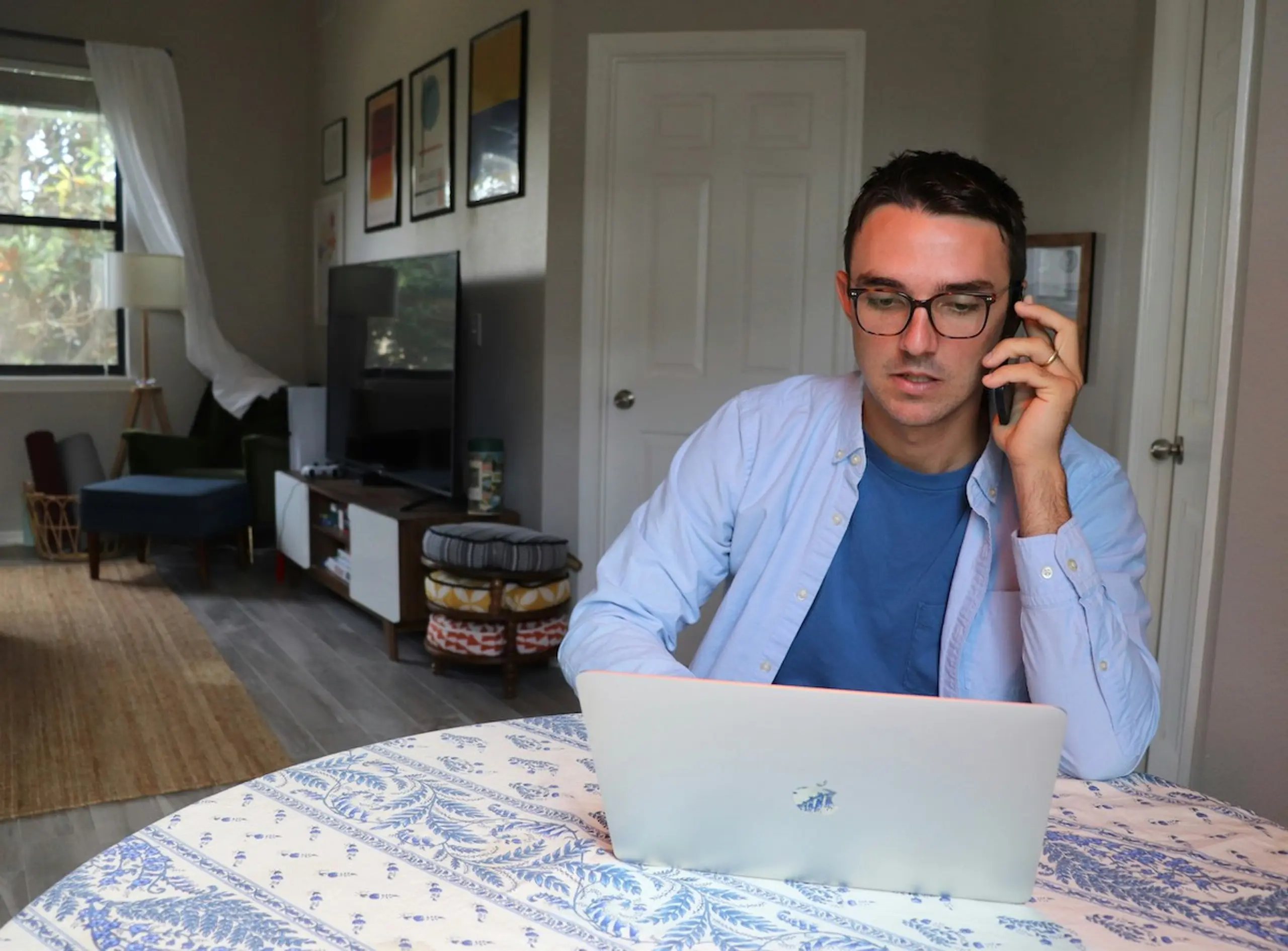 A man on the phone and the computer