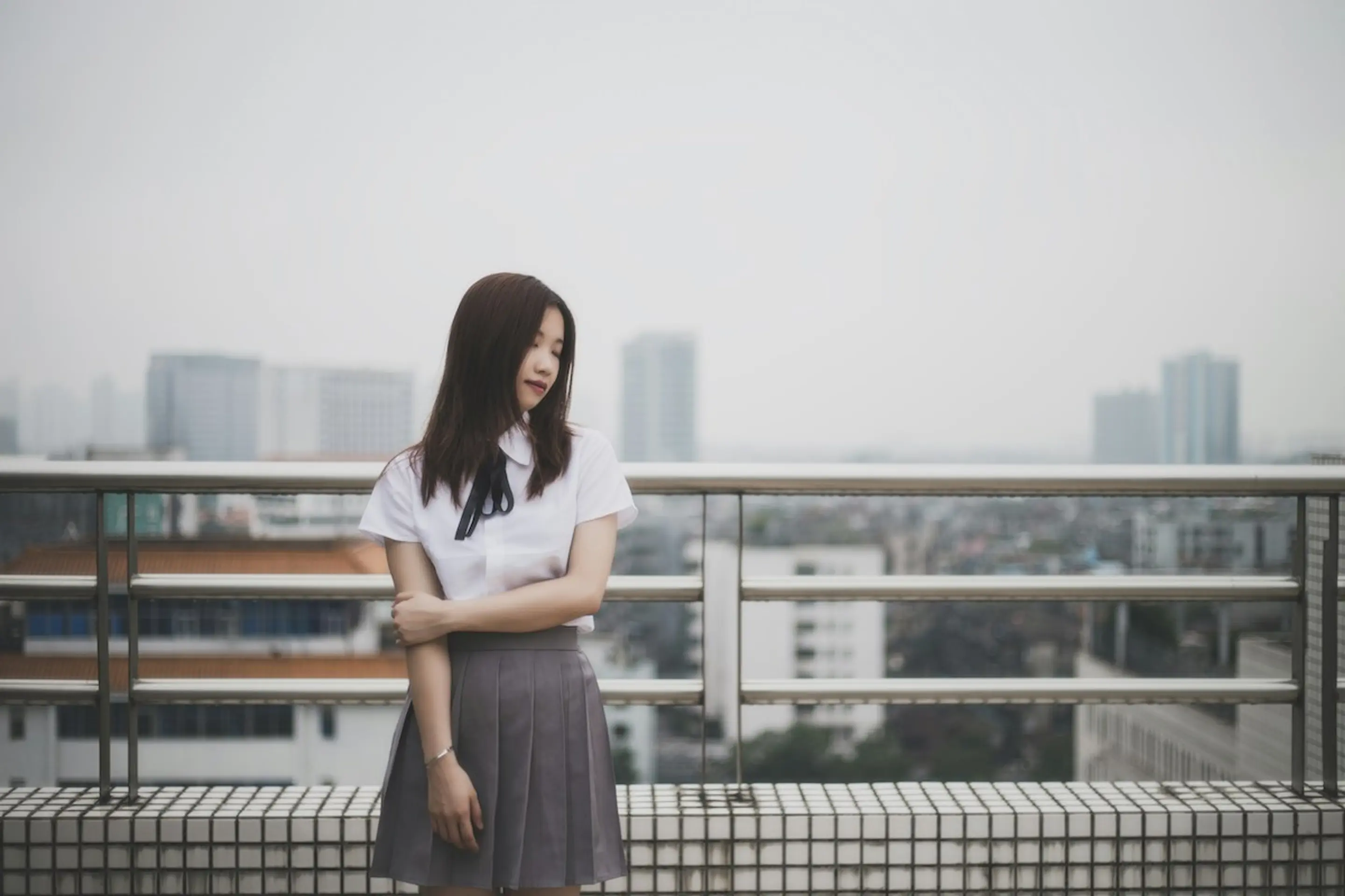A woman holding her arm on a balcony