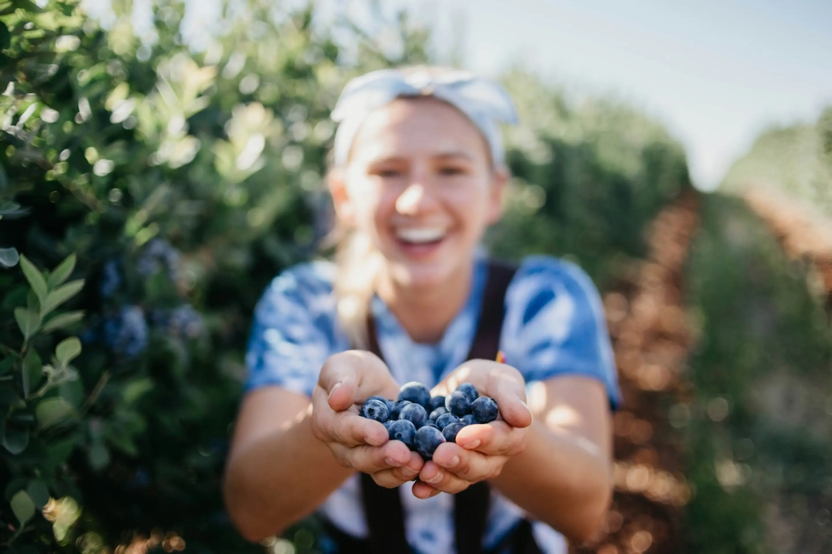 A woman with a handful of blueberries