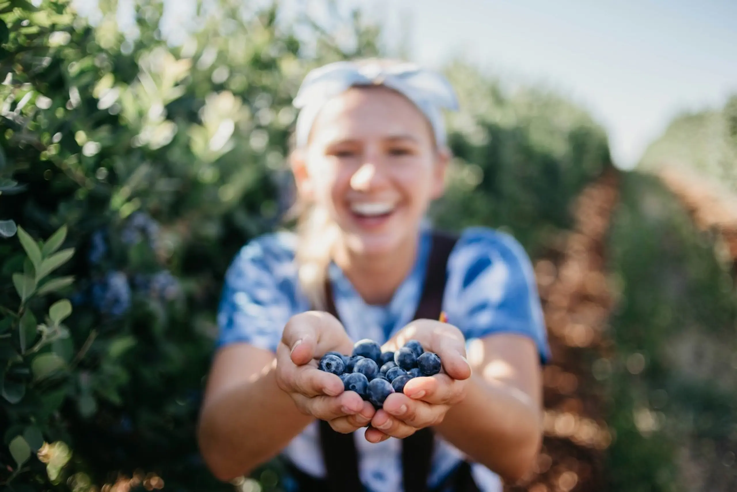 A woman with a handful of blueberries