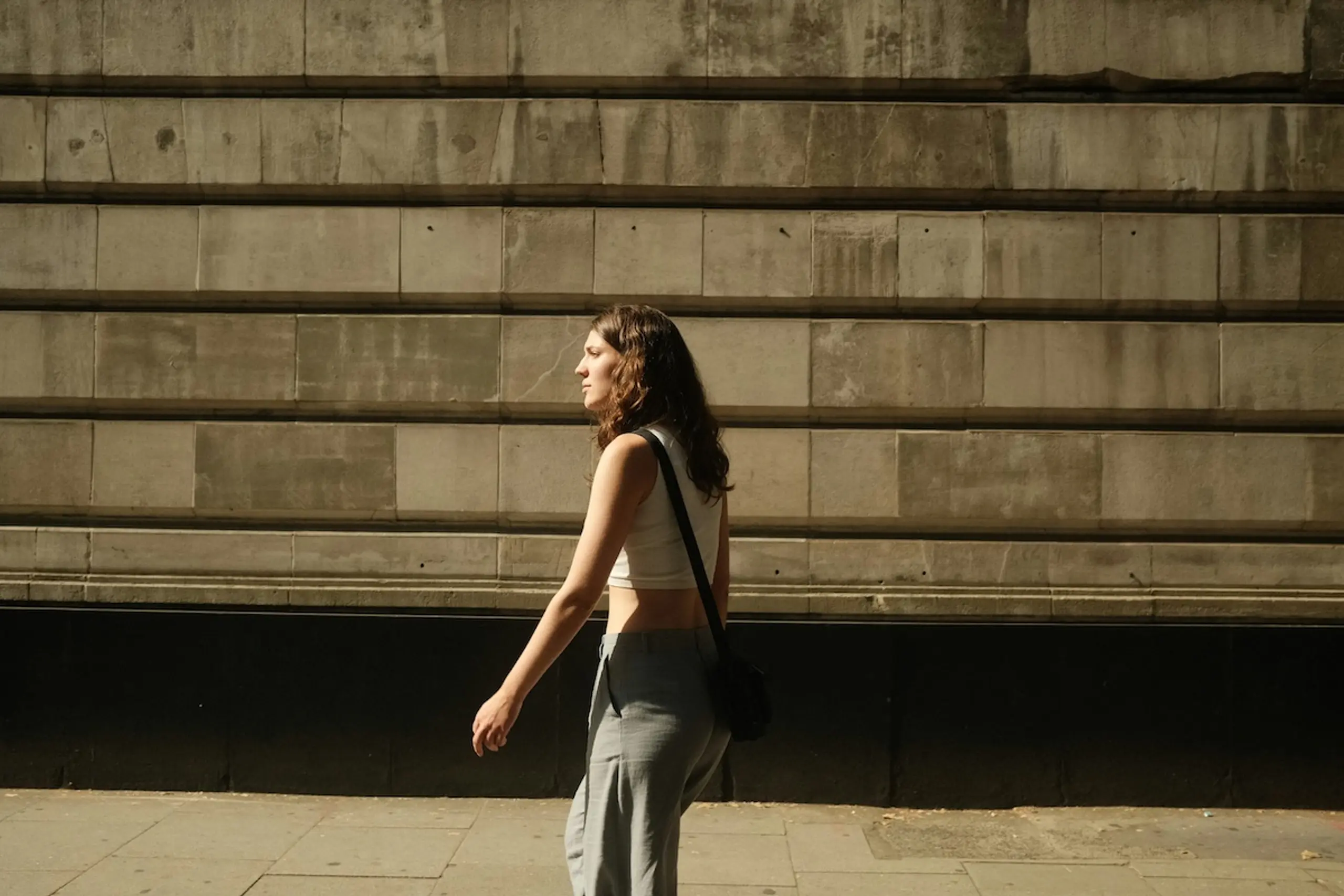 woman walking in front of building