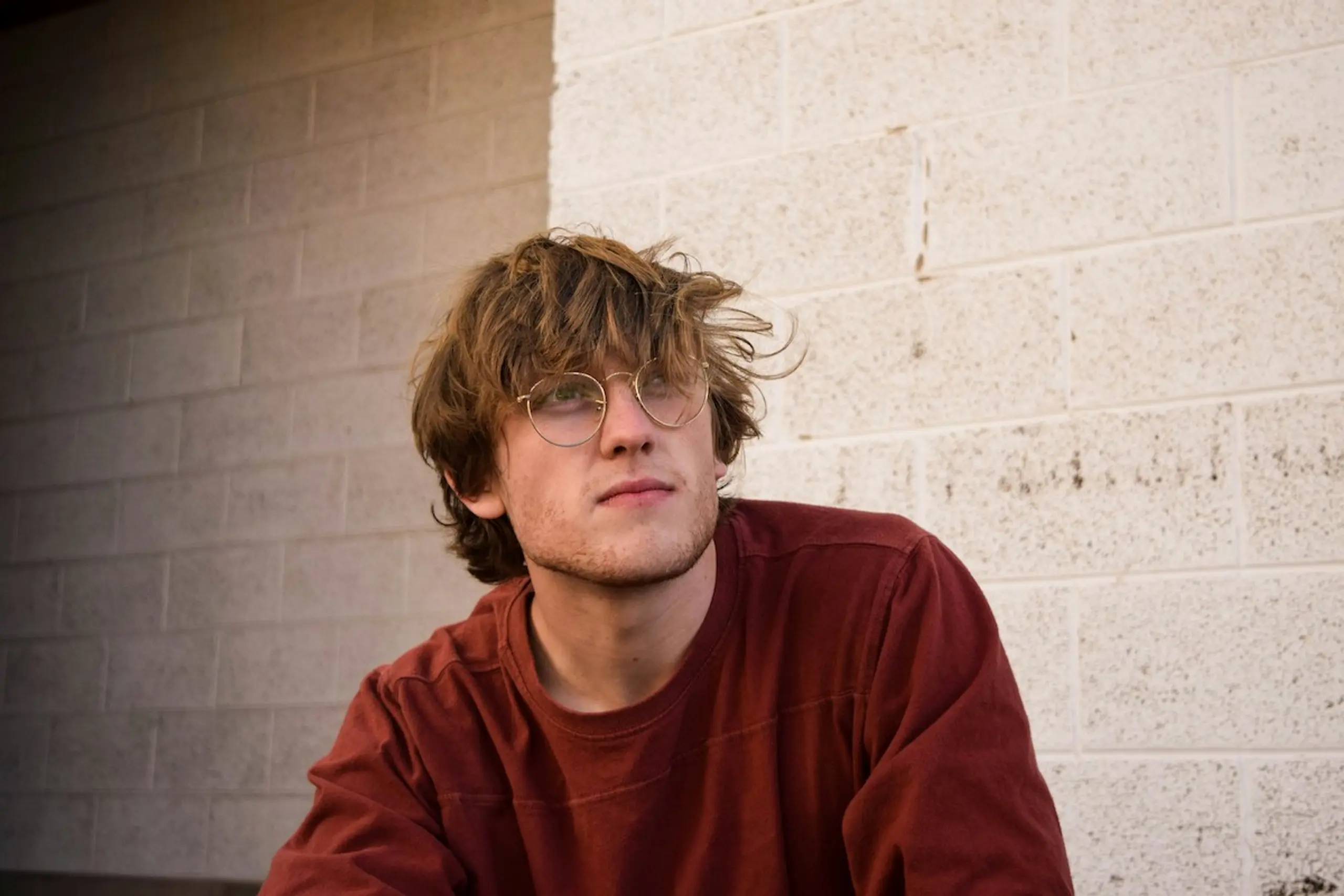 A man with glasses staring and thinking