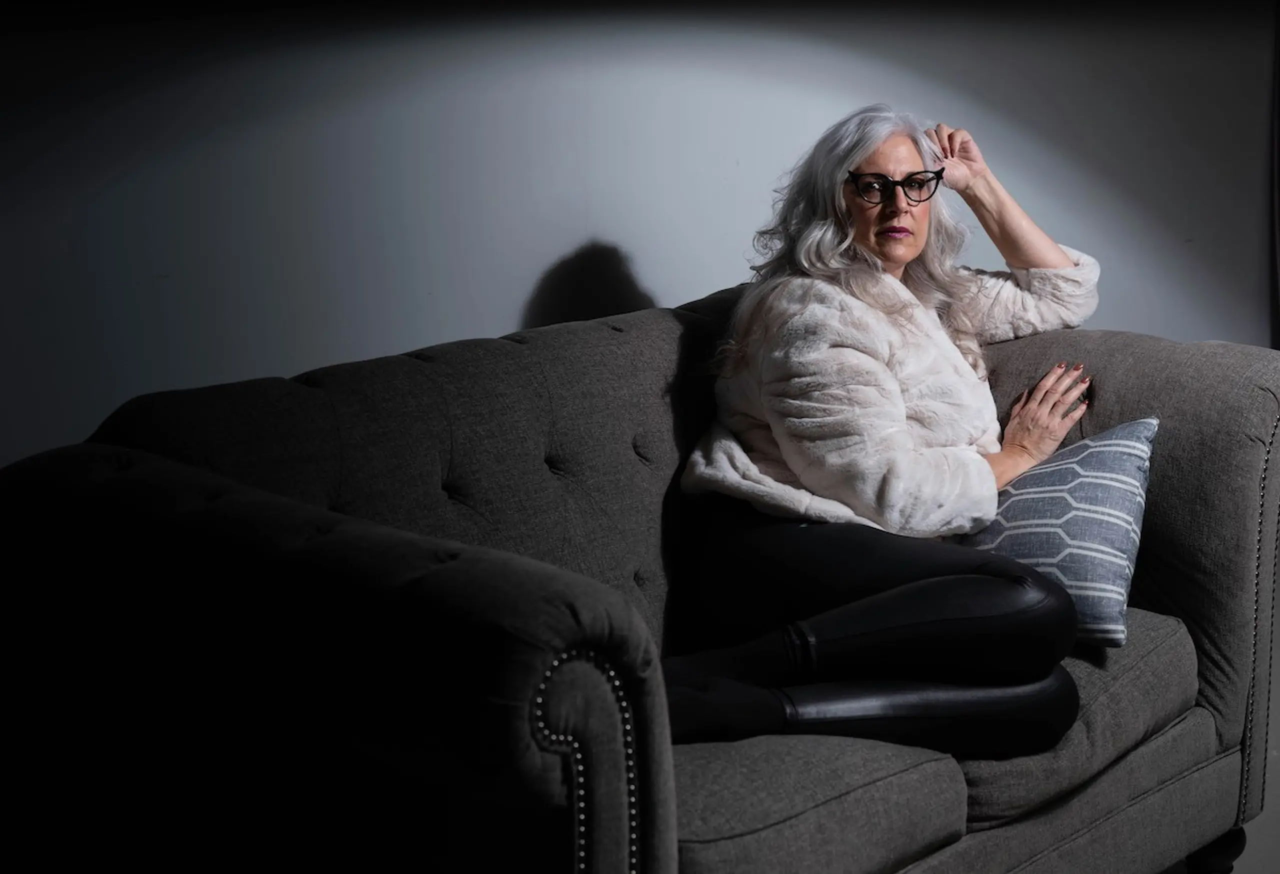 An older woman sitting on the couch