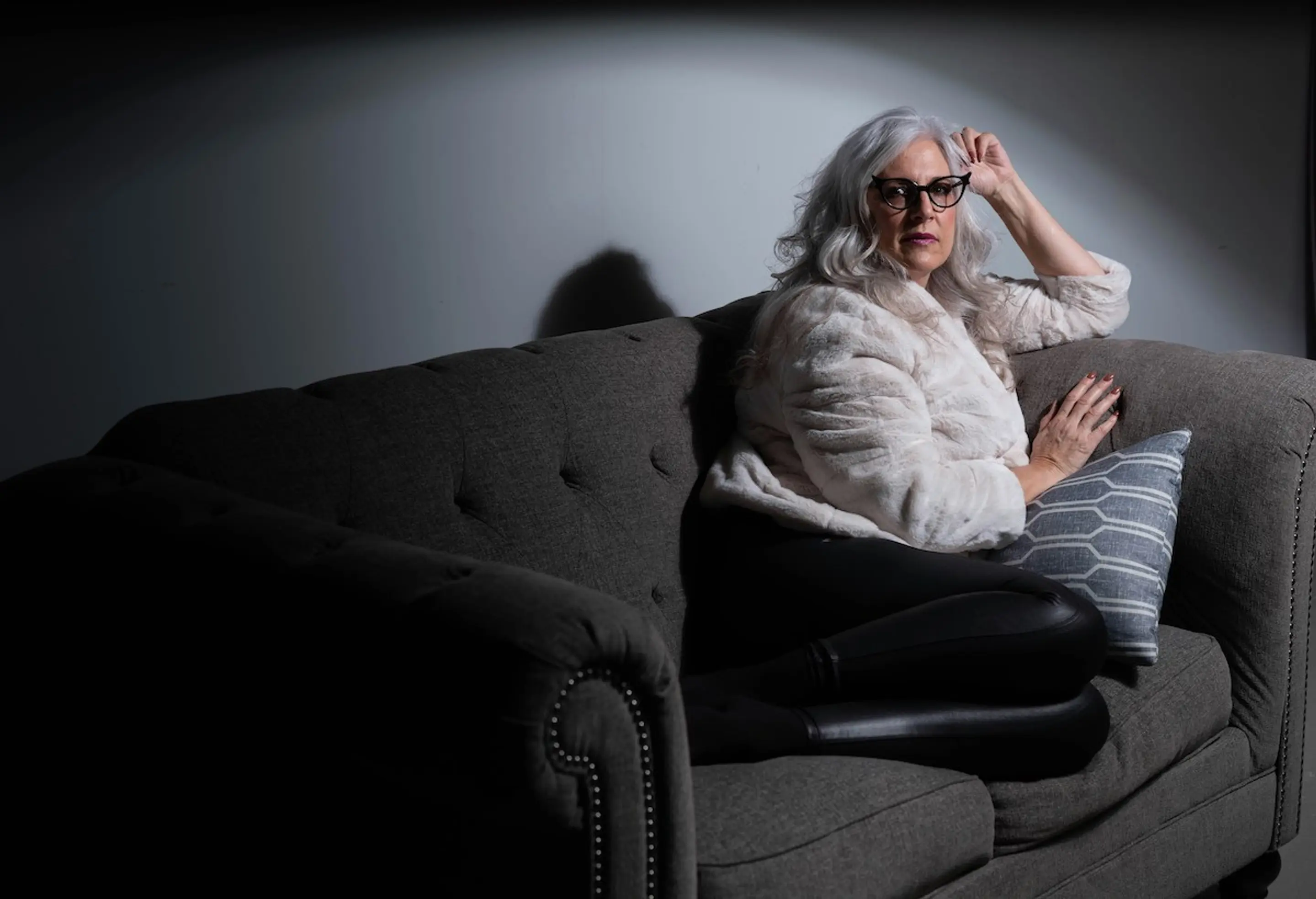 An older woman sitting on the couch