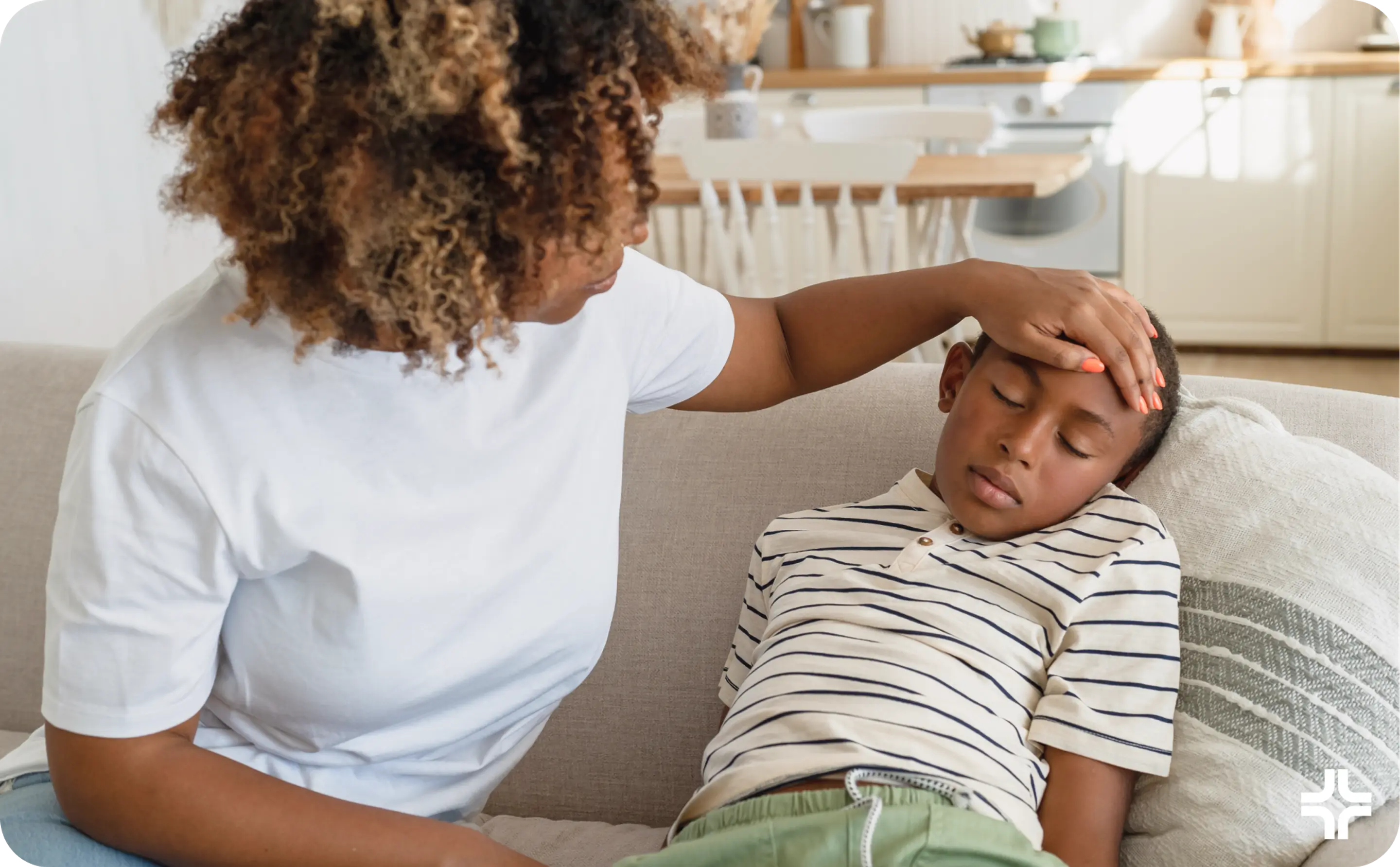 Mom feels son's forehead for temperature