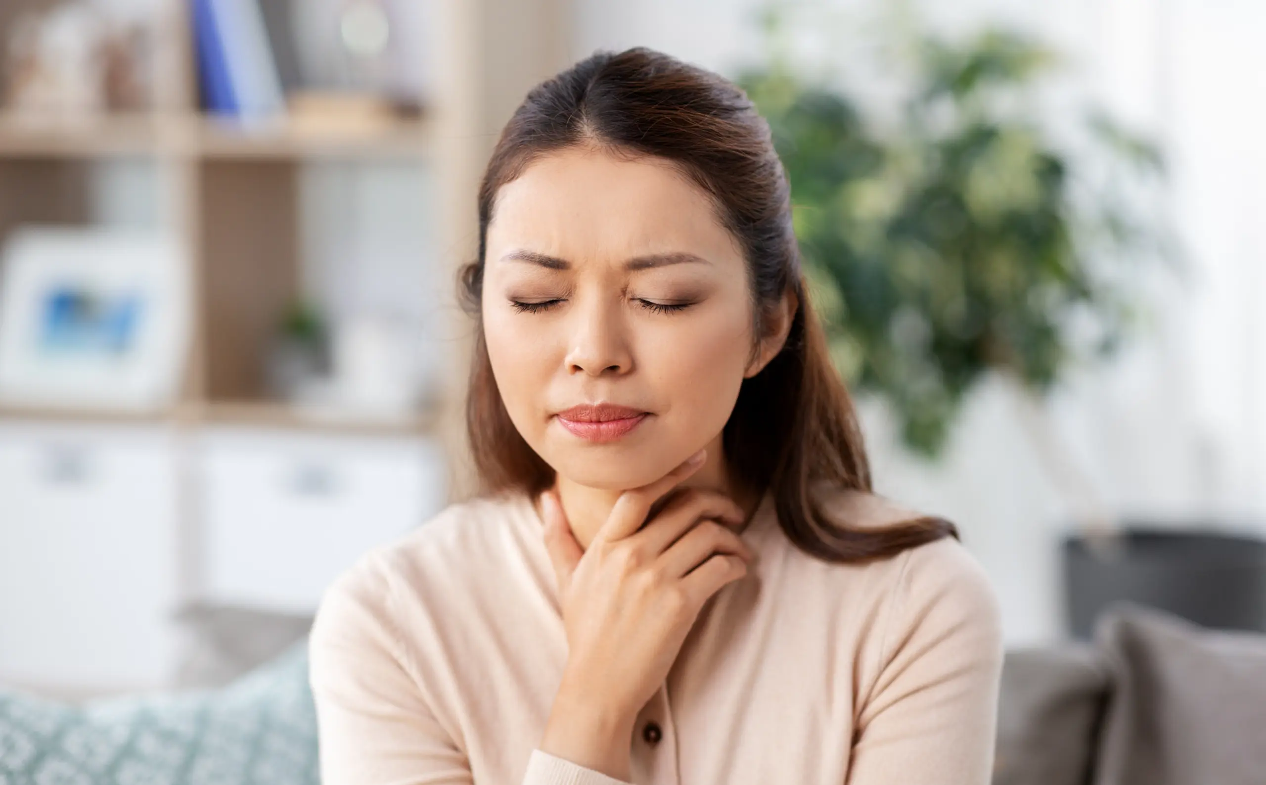 Woman holding throat