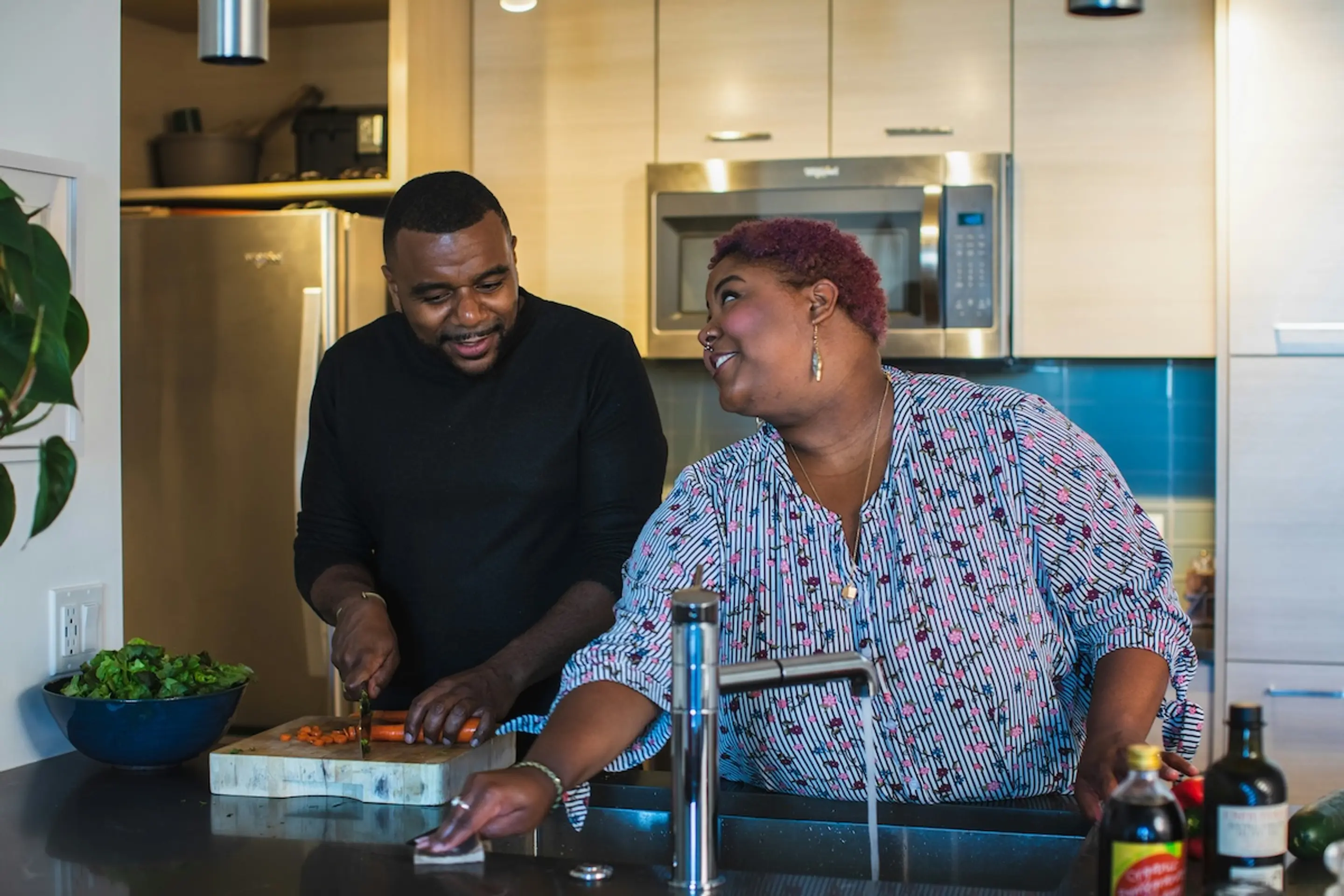 A man and woman preparing a meal in a kitchen