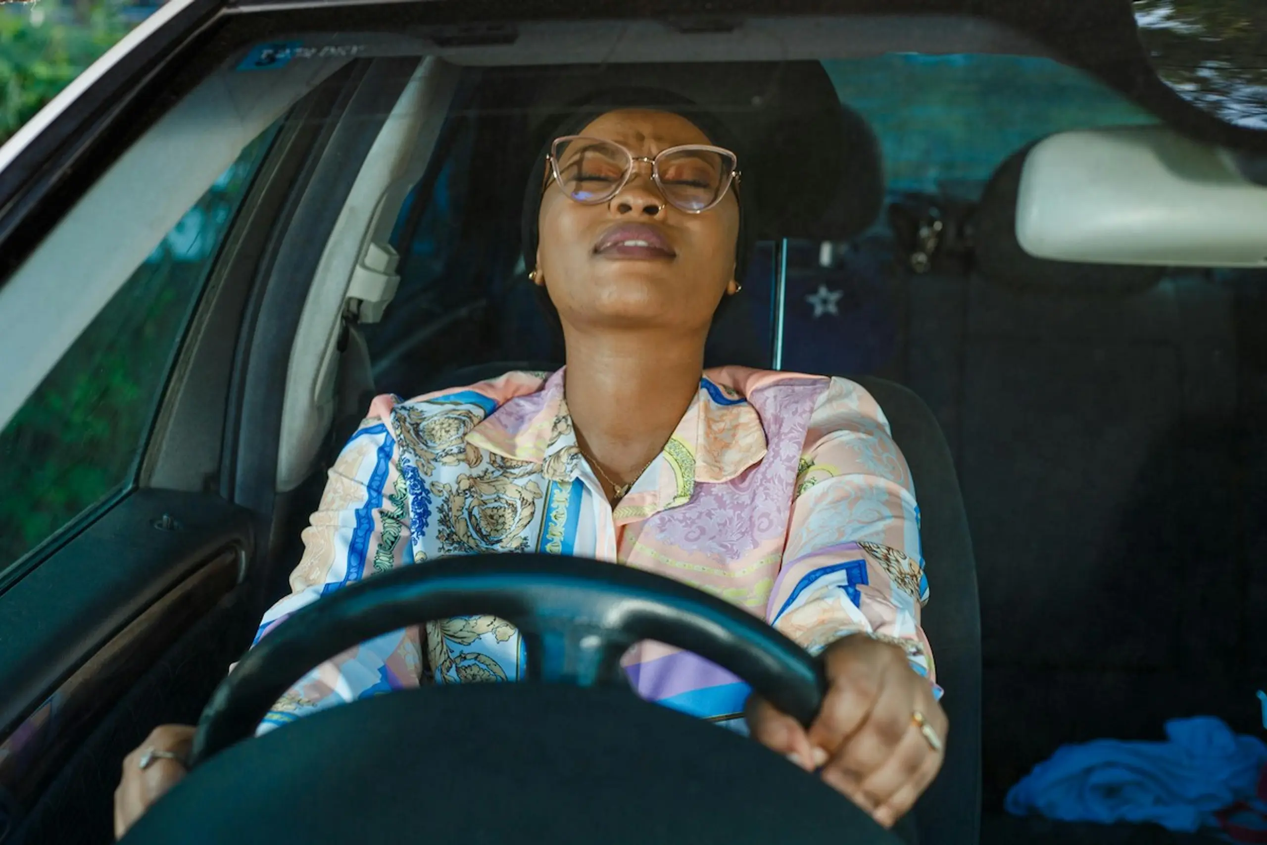 A stressed out woman driving her car