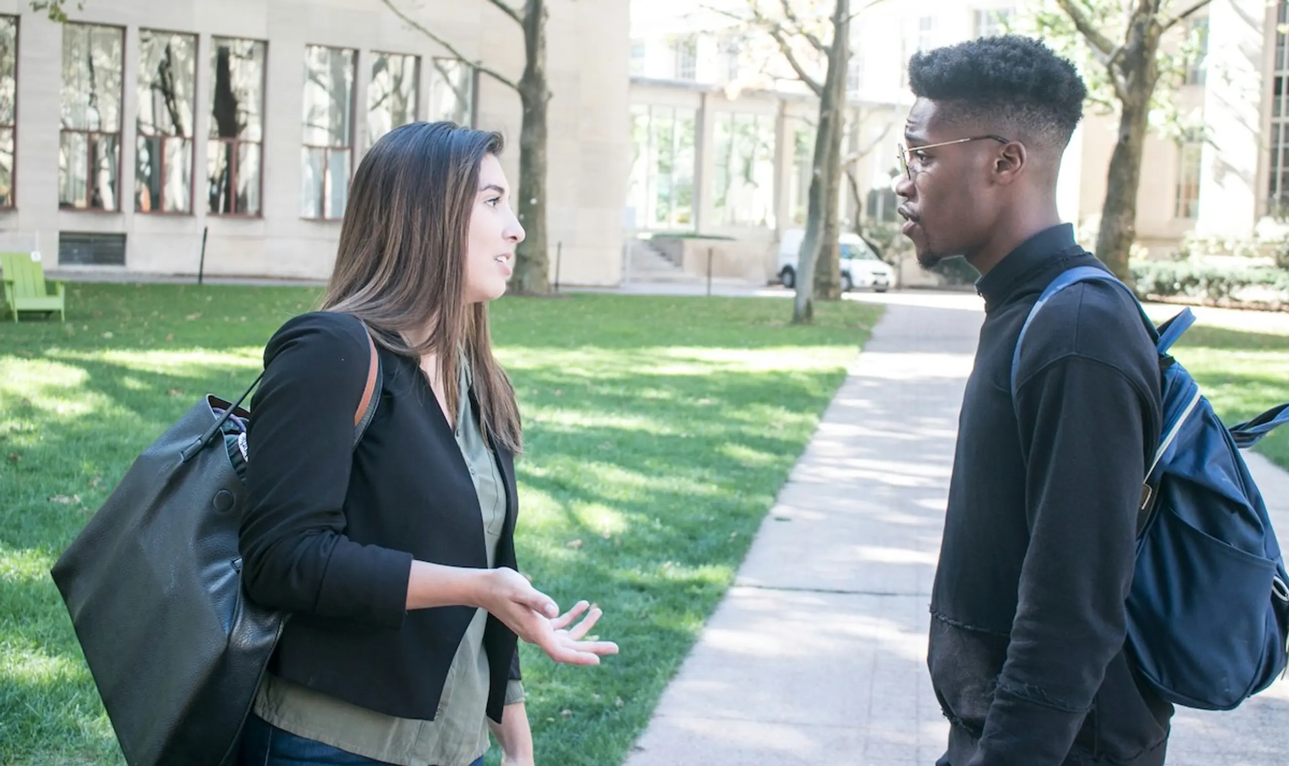 A woman giving advice to a man outside