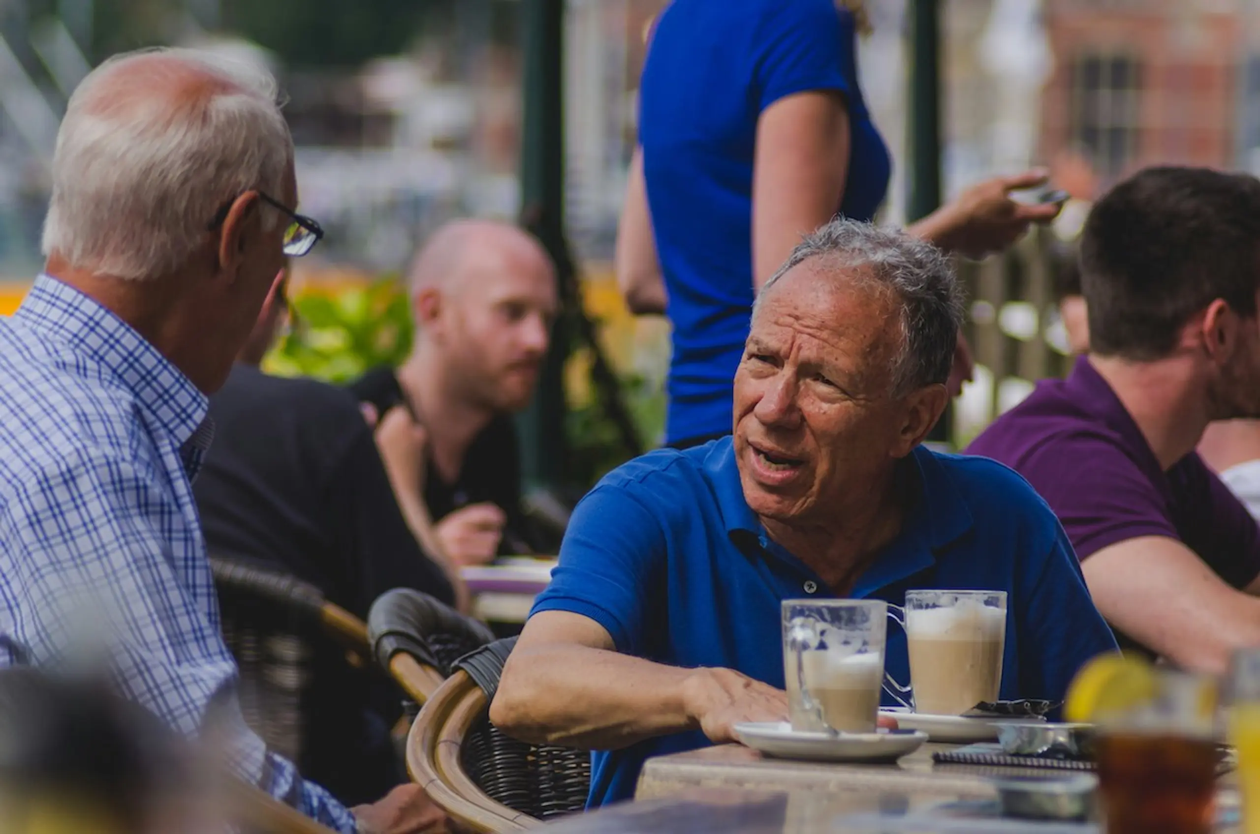 Two older men talking over a cup of coffee