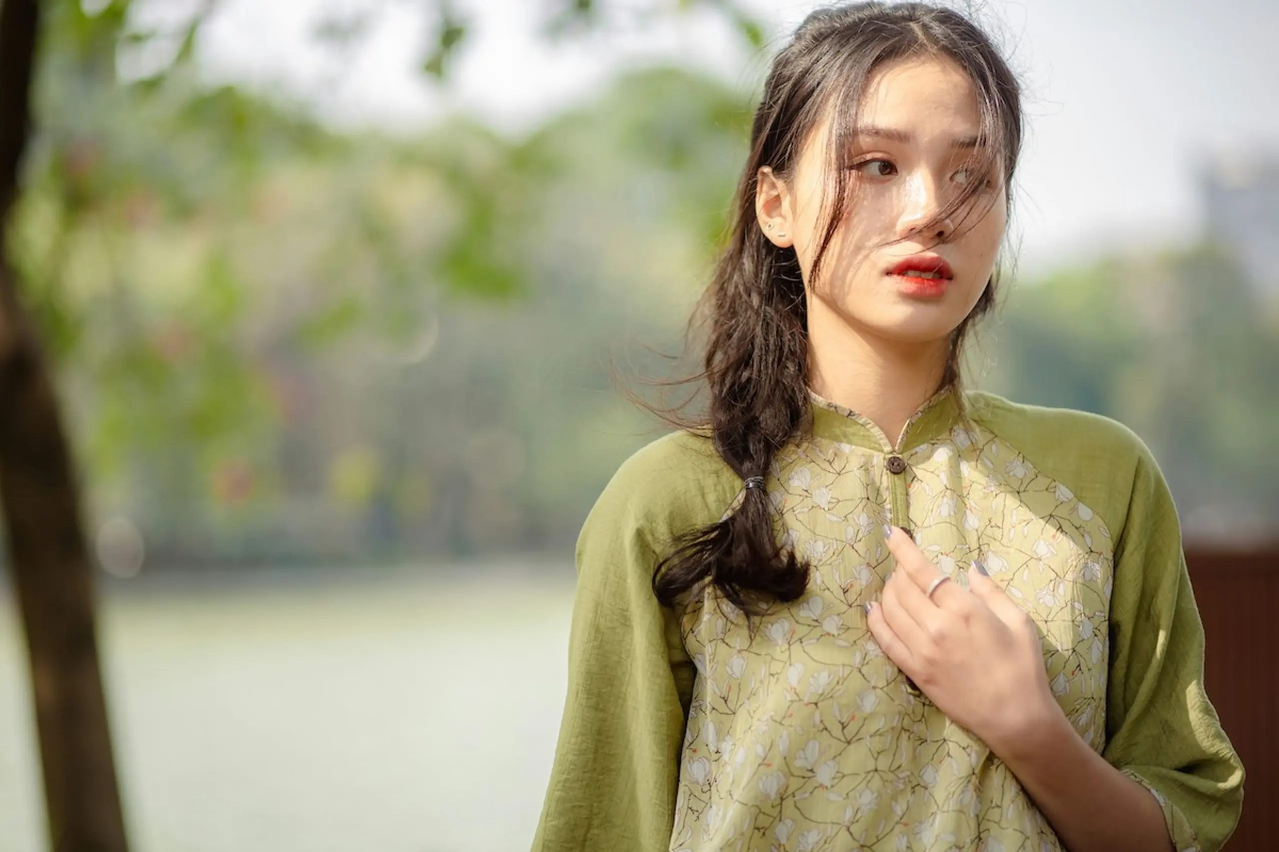 A woman holding her chest in discomfort