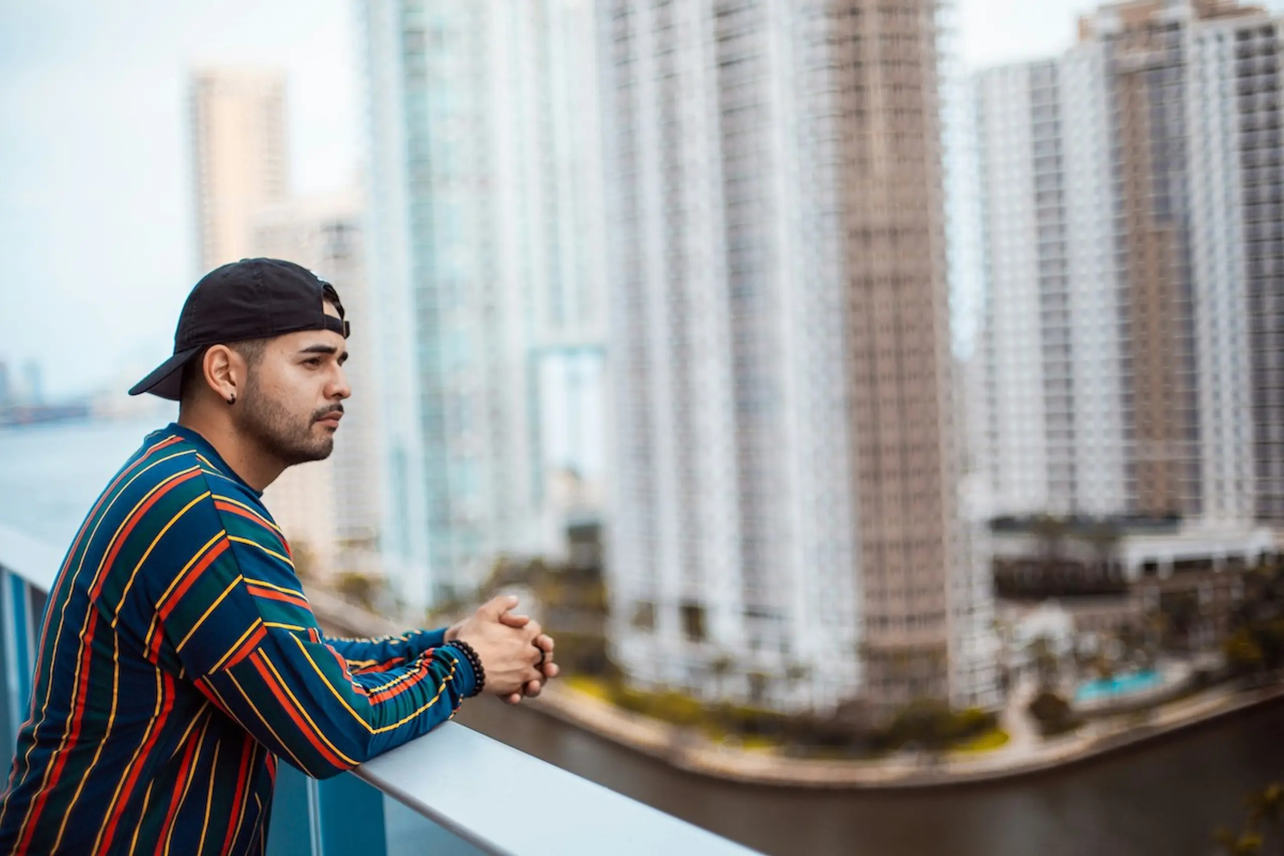 A concerned man looking out from his balcony