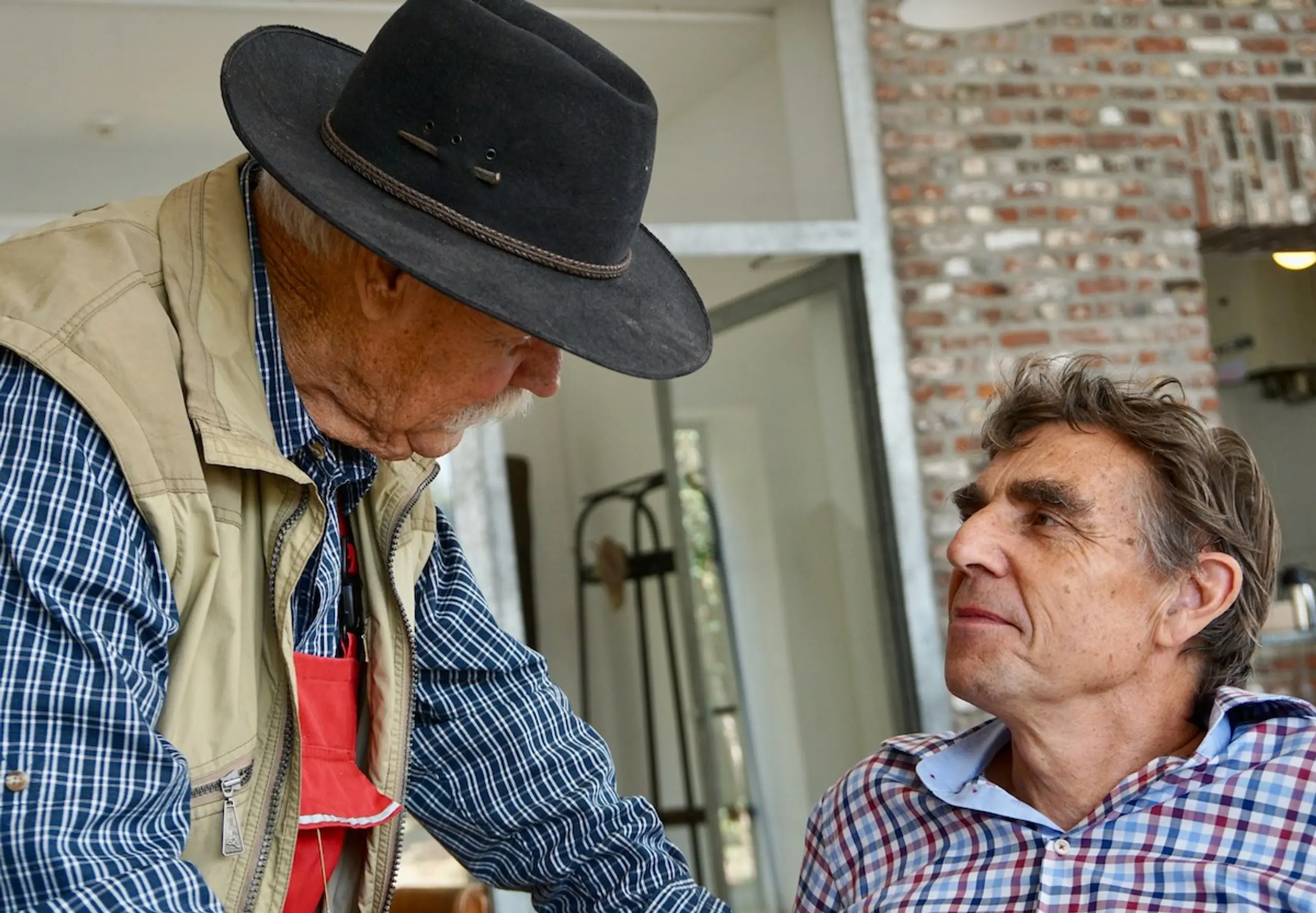 Two older men talking to each other