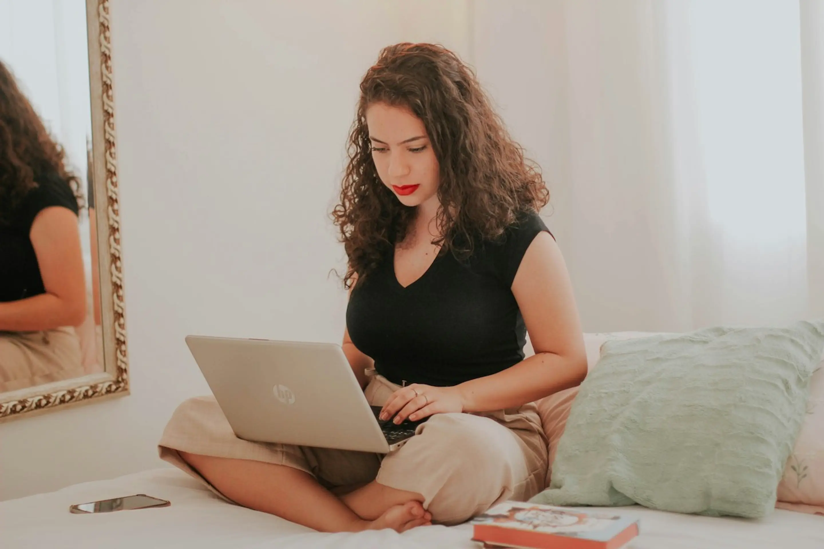A woman on her computer in bed