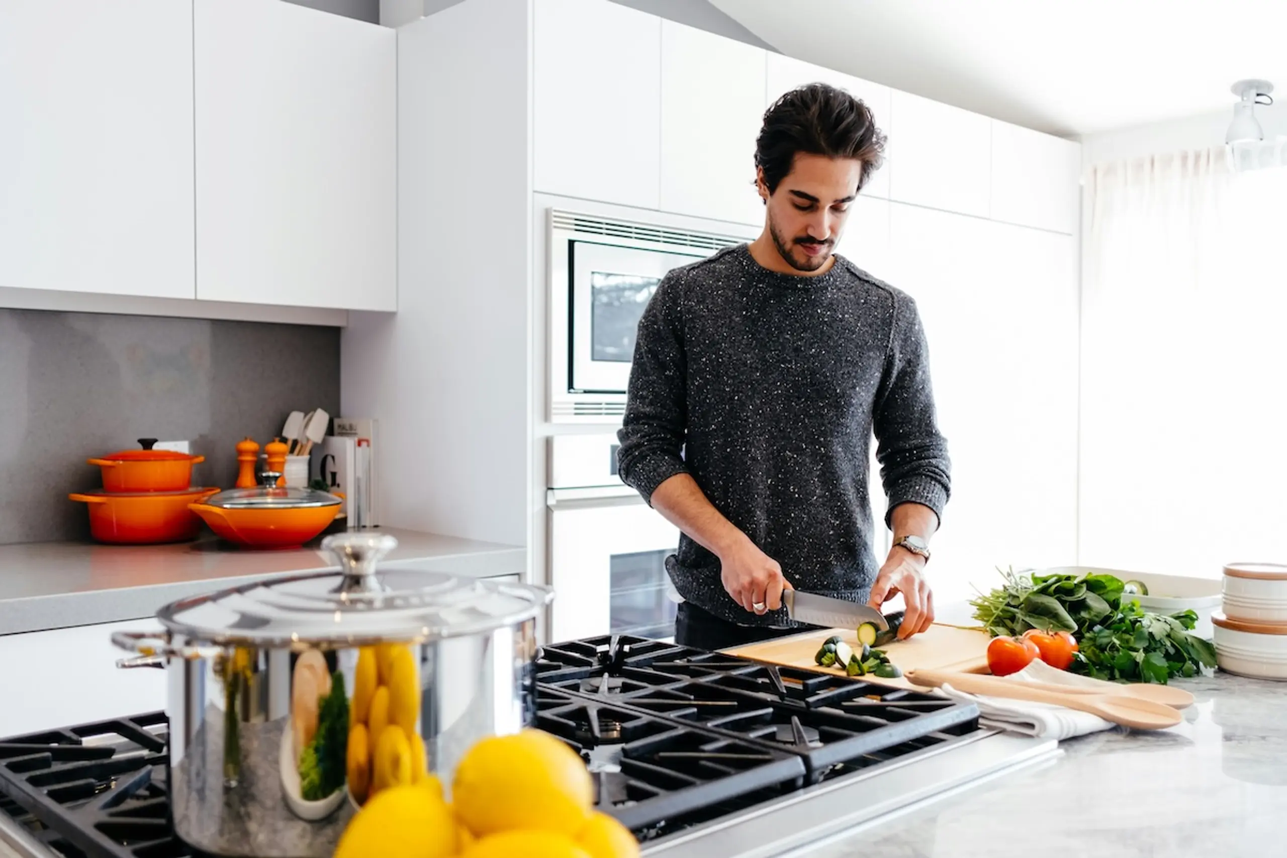 man cutting vegetables in a kitchen