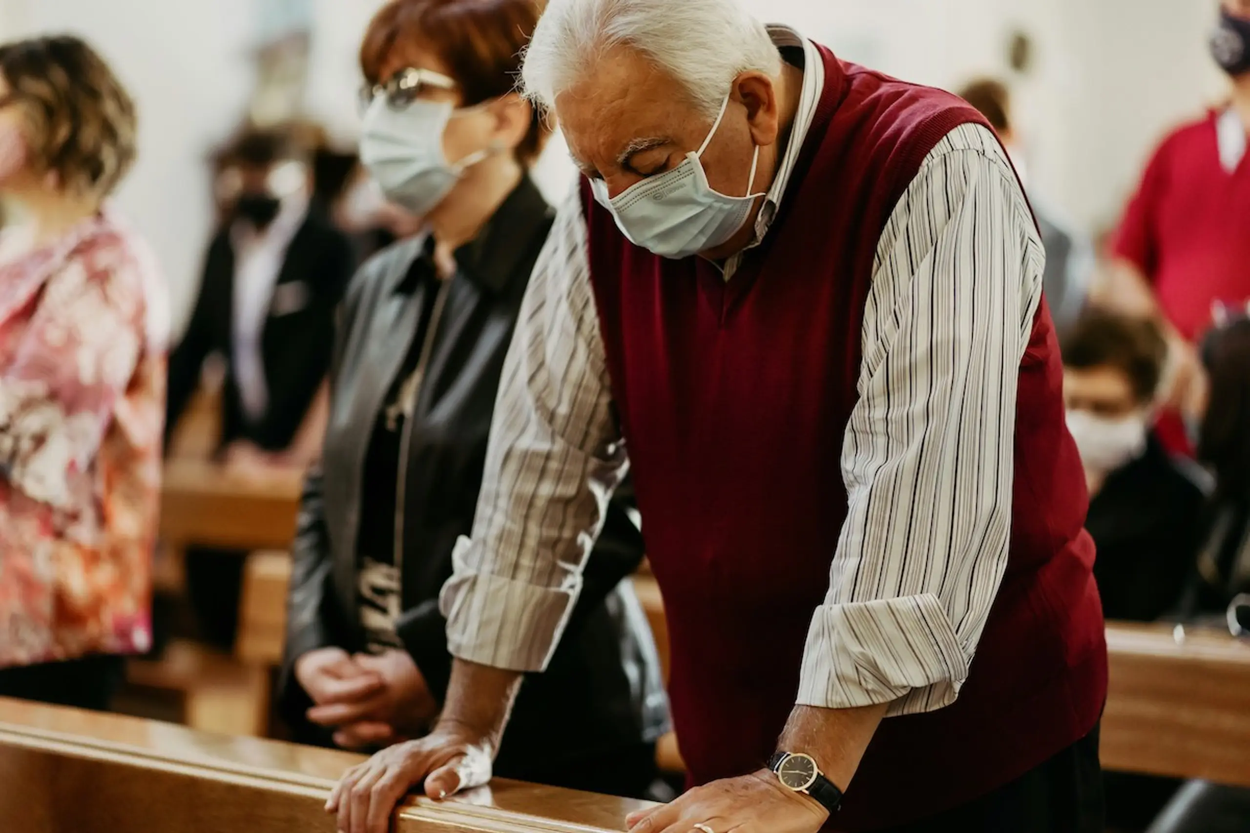 A man leaning forward with a covid mask on